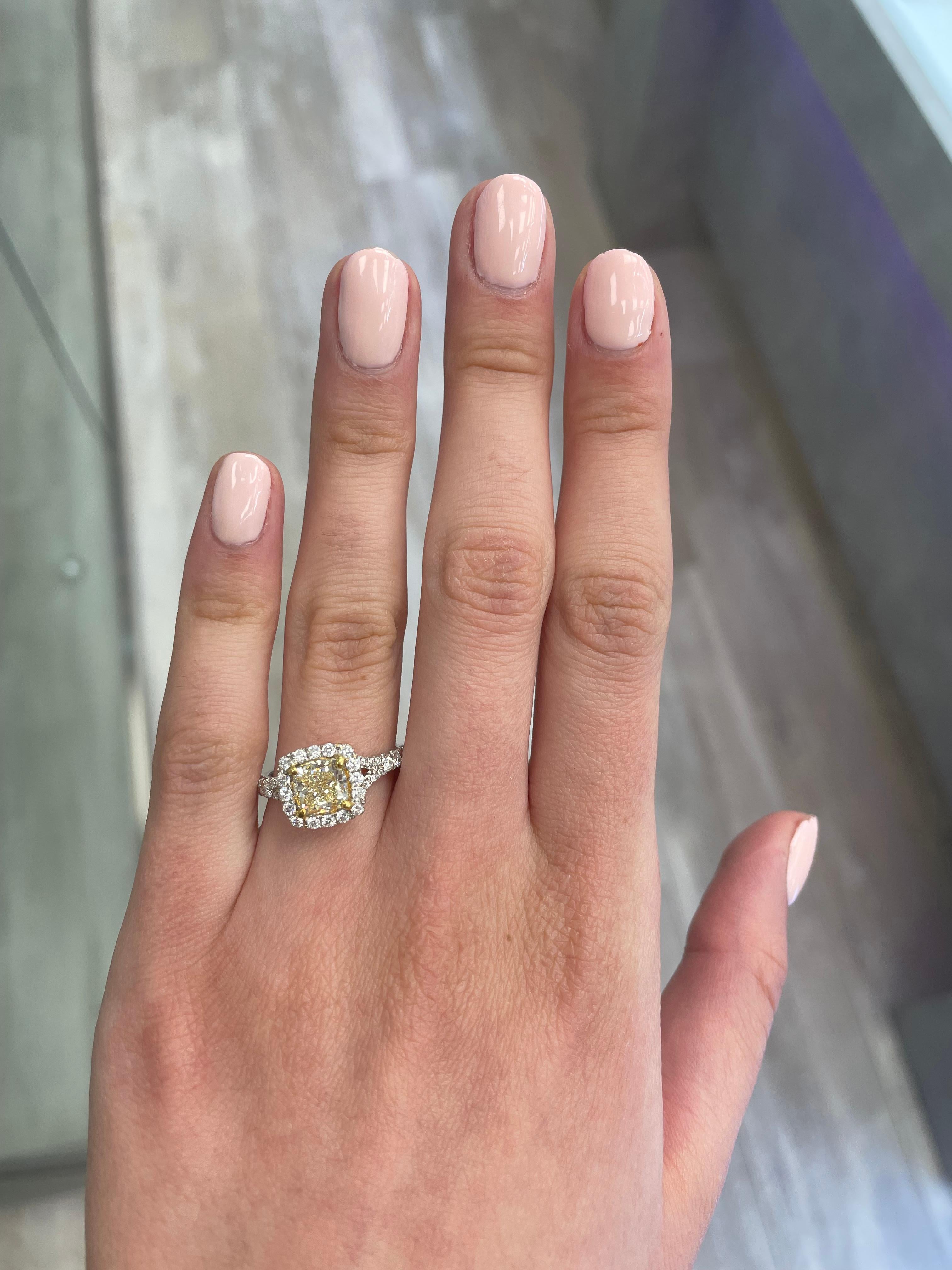 Stunning modern EGL certified yellow diamond with halo ring, two-tone 18k yellow and white gold, split shank. By Alexander Beverly Hills
2.16 carats total diamond weight.
1.57 carat cushion cut Fancy Light Yellow color and VS2 clarity diamond, EGL