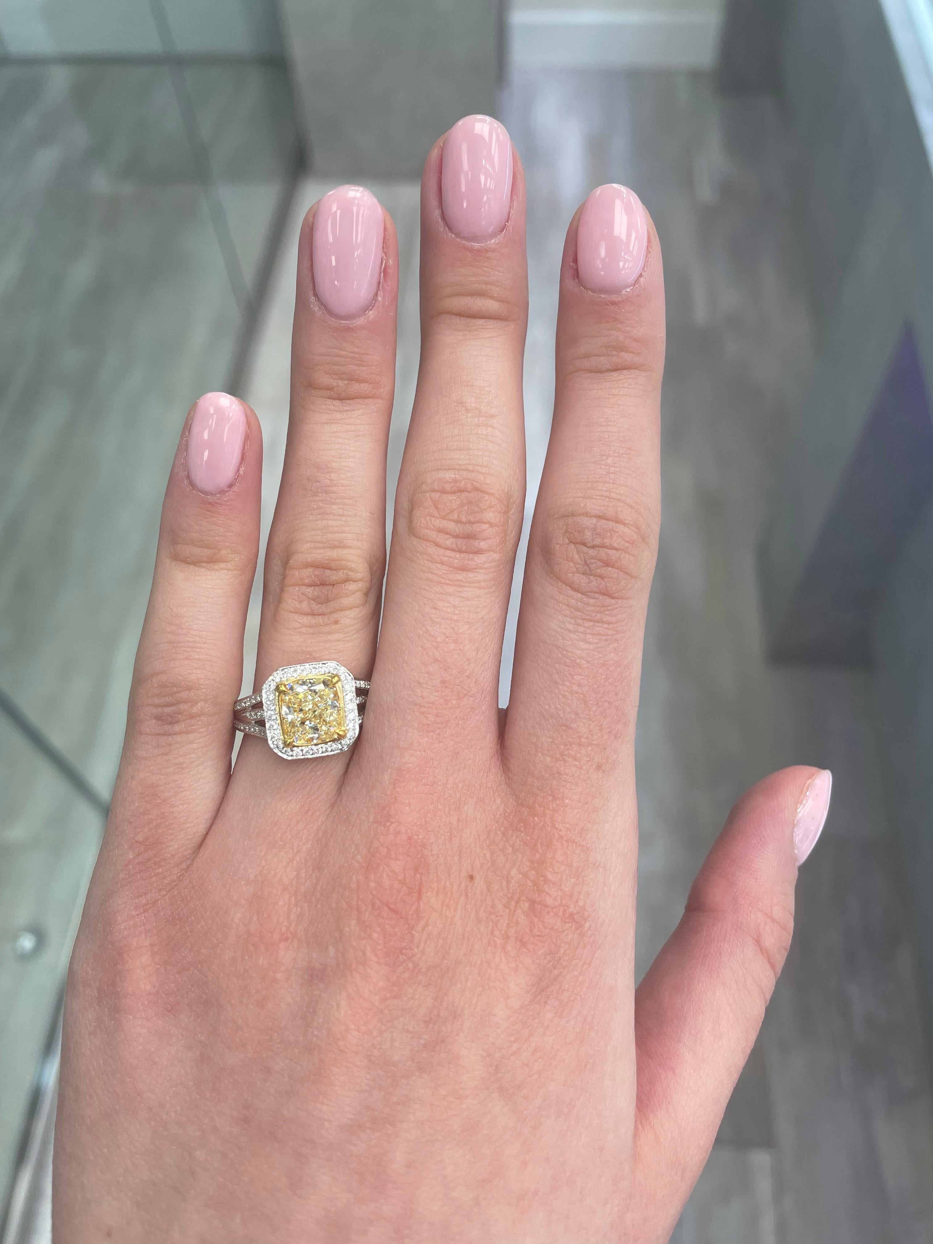 Stunning modern EGL certified fancy yellow diamond halo ring, two-tone 18k yellow and white gold, split shank. By Alexander Beverly Hills
2.78 carats total diamond weight.
2.17 carat cushion Fancy Yellow color and VVS2 clarity diamond, EGL graded.