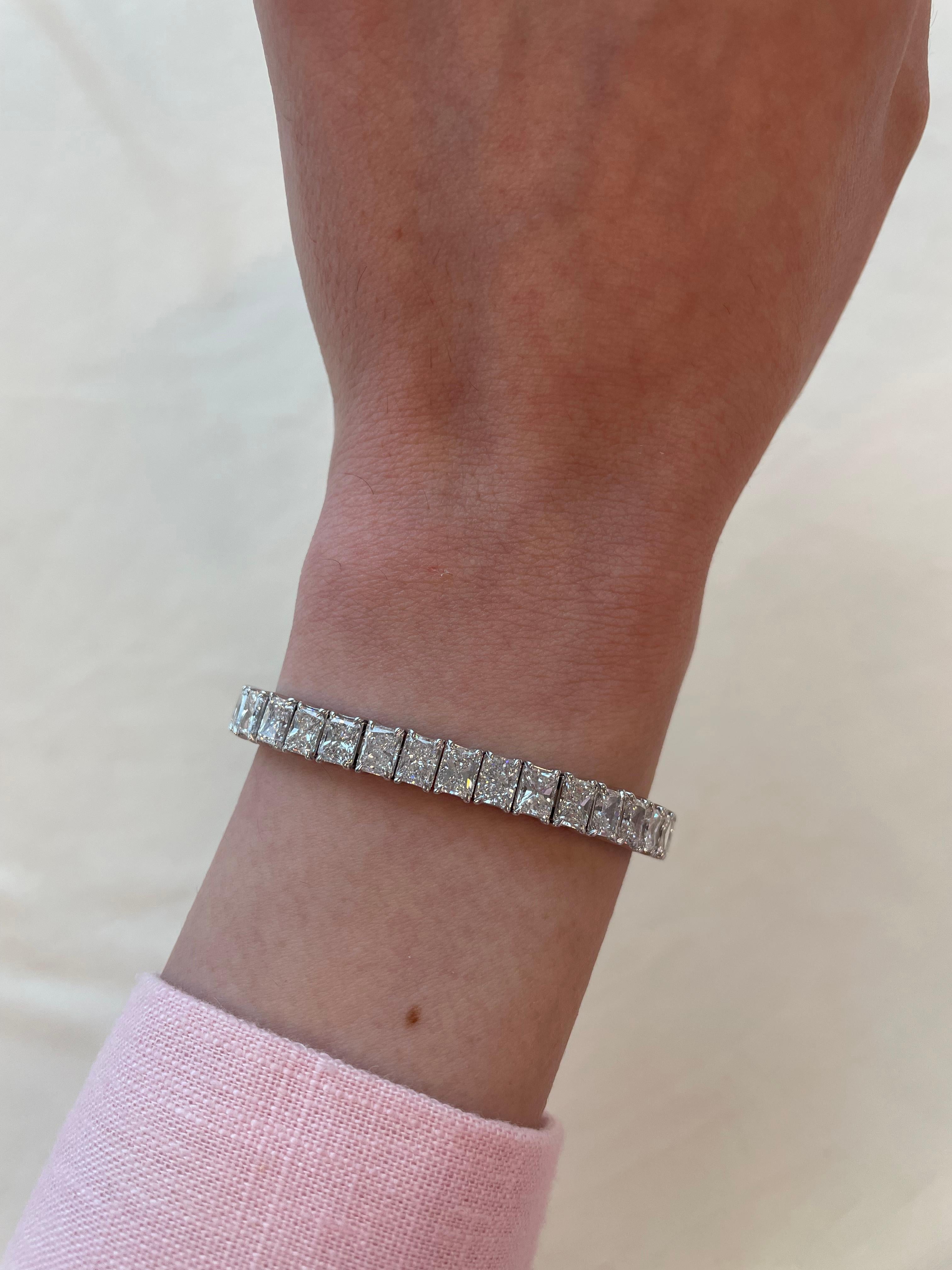Stunning modern straight radiant cut diamond tennis bracelet. High jewelry by Alexander Beverly Hills.
43 radiant cut diamonds, 21.80 carats. Approximately E/F color and VS clarity. 18k white gold, 26.40 grams, 7 inches.
Accommodated with an up to