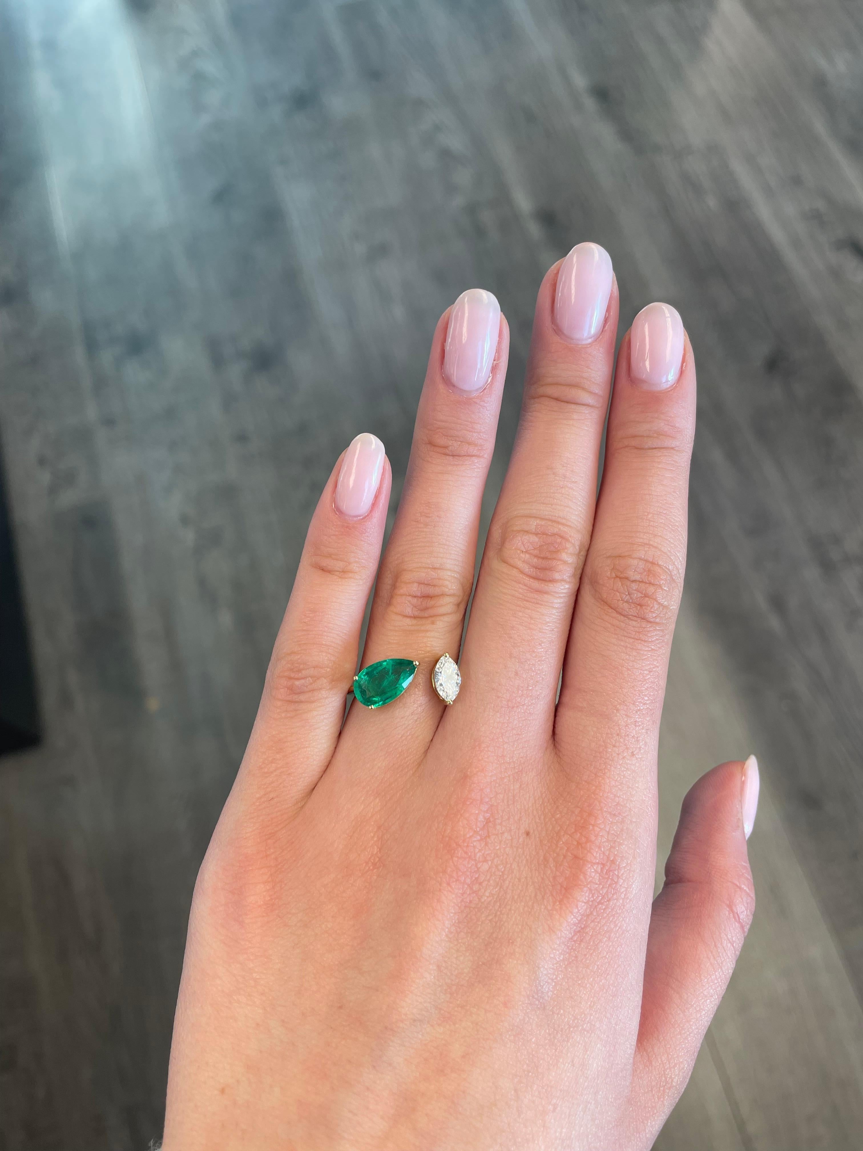 Stunning modern floating emerald and diamond toi et moi ring. By Alexander Beverly Hills.
1.67carat pear shape emerald. 0.52 carat marques cut diamond, approximately G/H color, and VS clarity. 18-karat yellow gold, 3.57 grams, current ring size