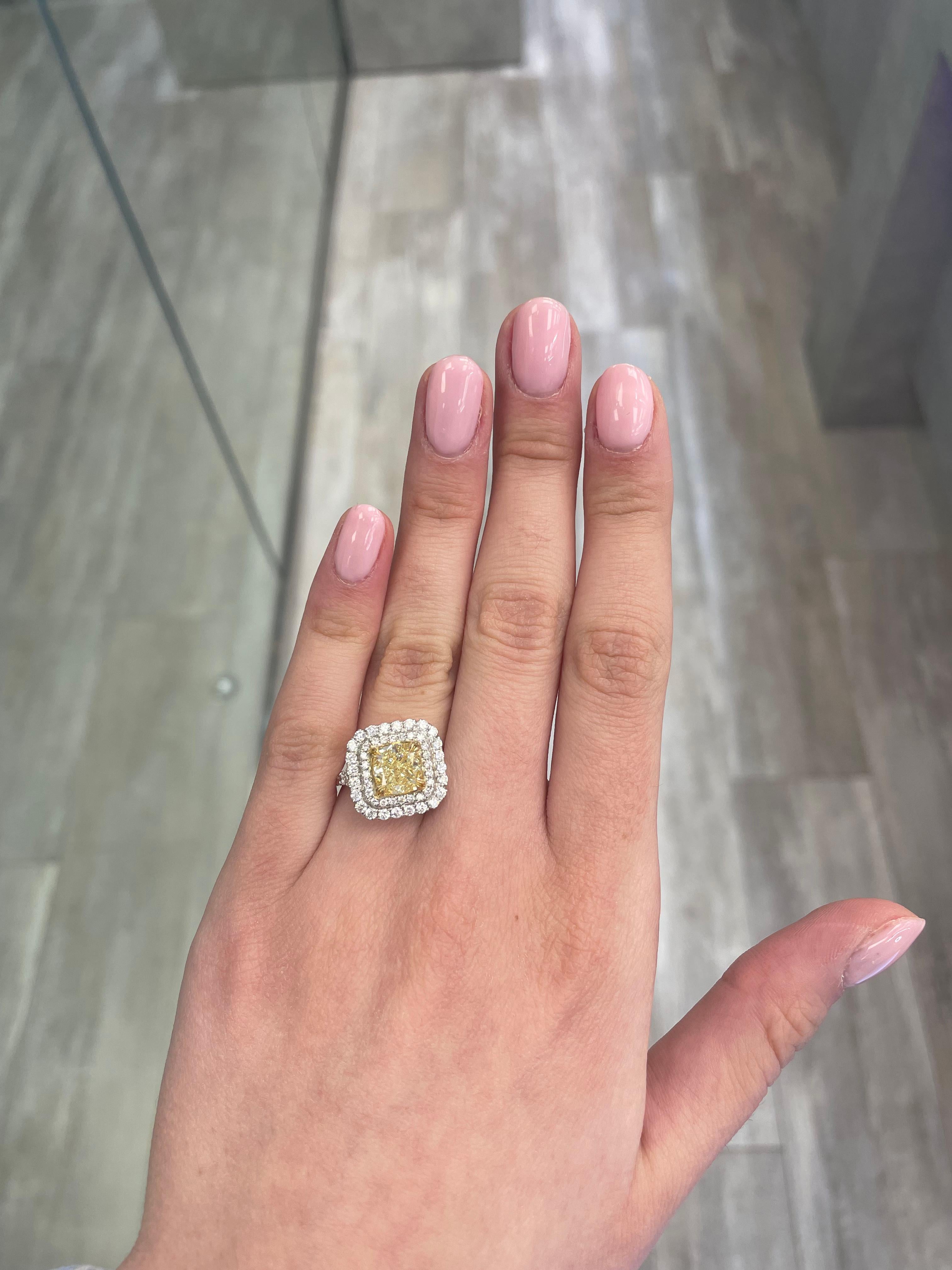Stunning modern EGL certified fancy intense yellow diamond double halo ring, two-tone 18k yellow and white gold, split shank. By Alexander Beverly Hills
3.25 carats total diamond weight.
2.22 carat cushion cut Fancy Intense Yellow color and VS2