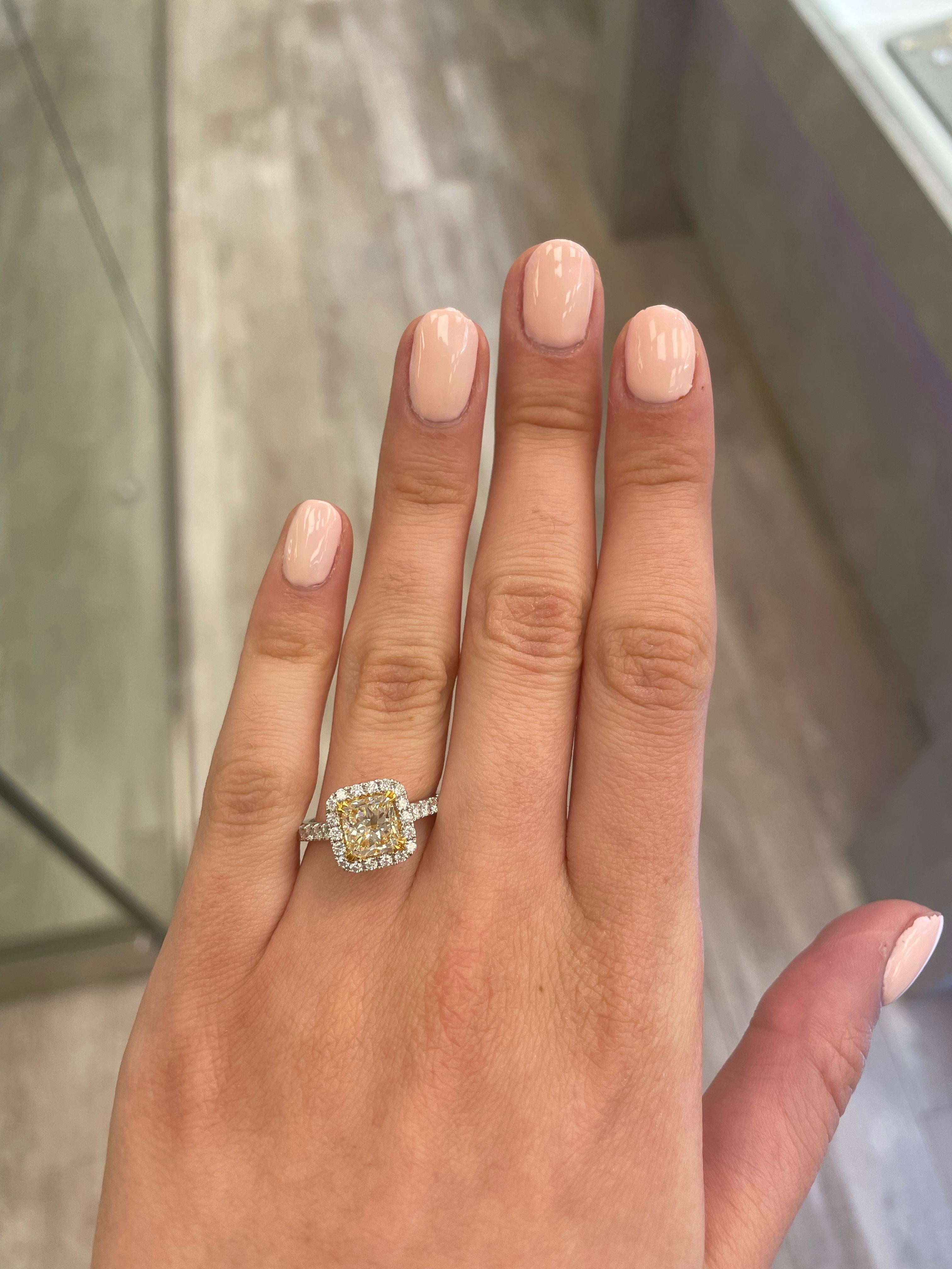 Stunning modern EGL certified yellow diamond with halo ring, two-tone 18k yellow and white gold. By Alexander Beverly Hills
2.27 carats total diamond weight.
1.58 carat cushion cut Fancy Light Yellow color and VVS2 clarity diamond, EGL graded.
