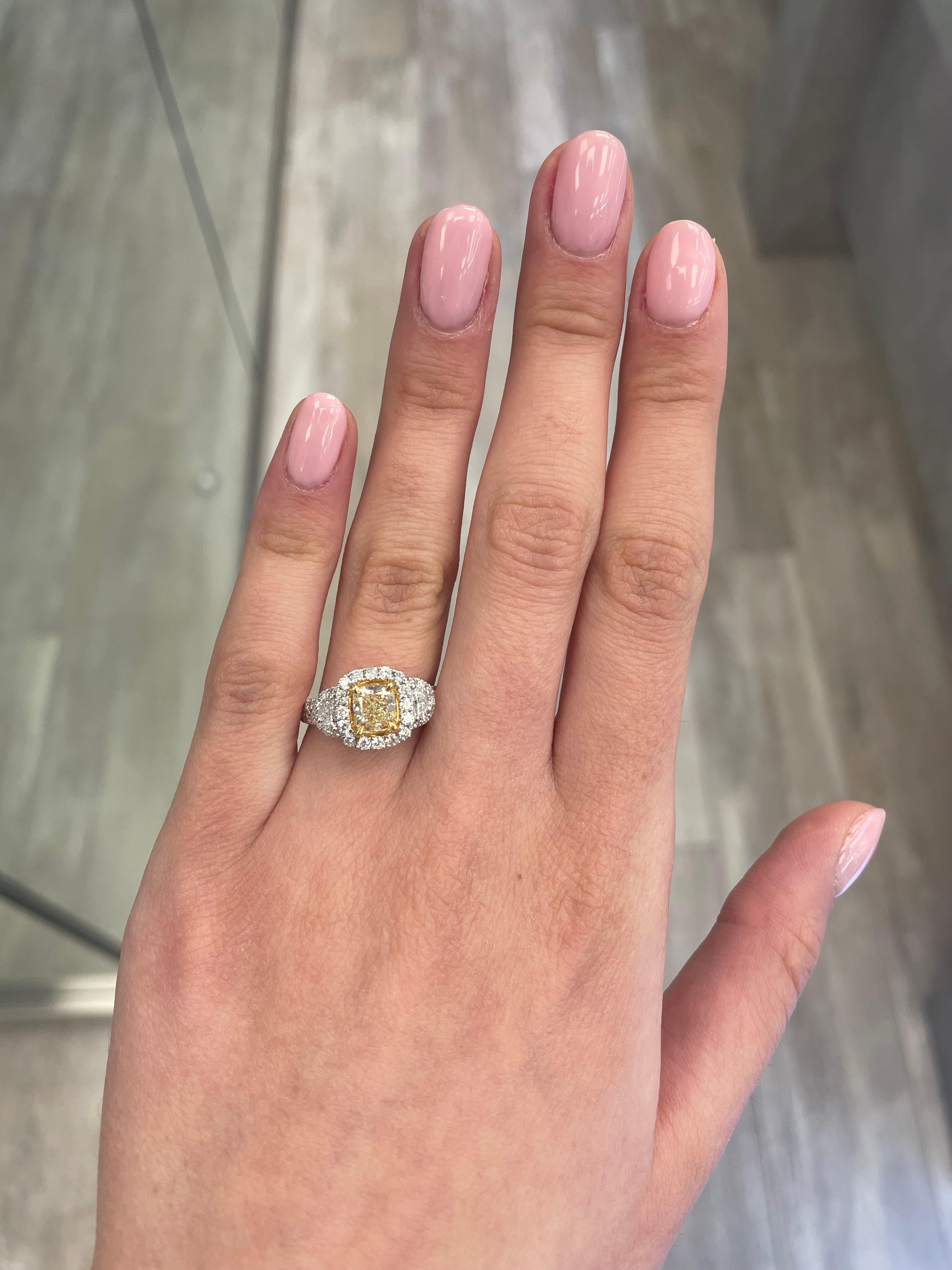 Stunning modern EGL certified fancy yellow diamond three stone halo ring, two-tone 18k yellow and white gold, split shank. By Alexander Beverly Hills
2.27 carats total diamond weight.
1.51 carat cushion Fancy Yellow color and VS1 clarity diamond,
