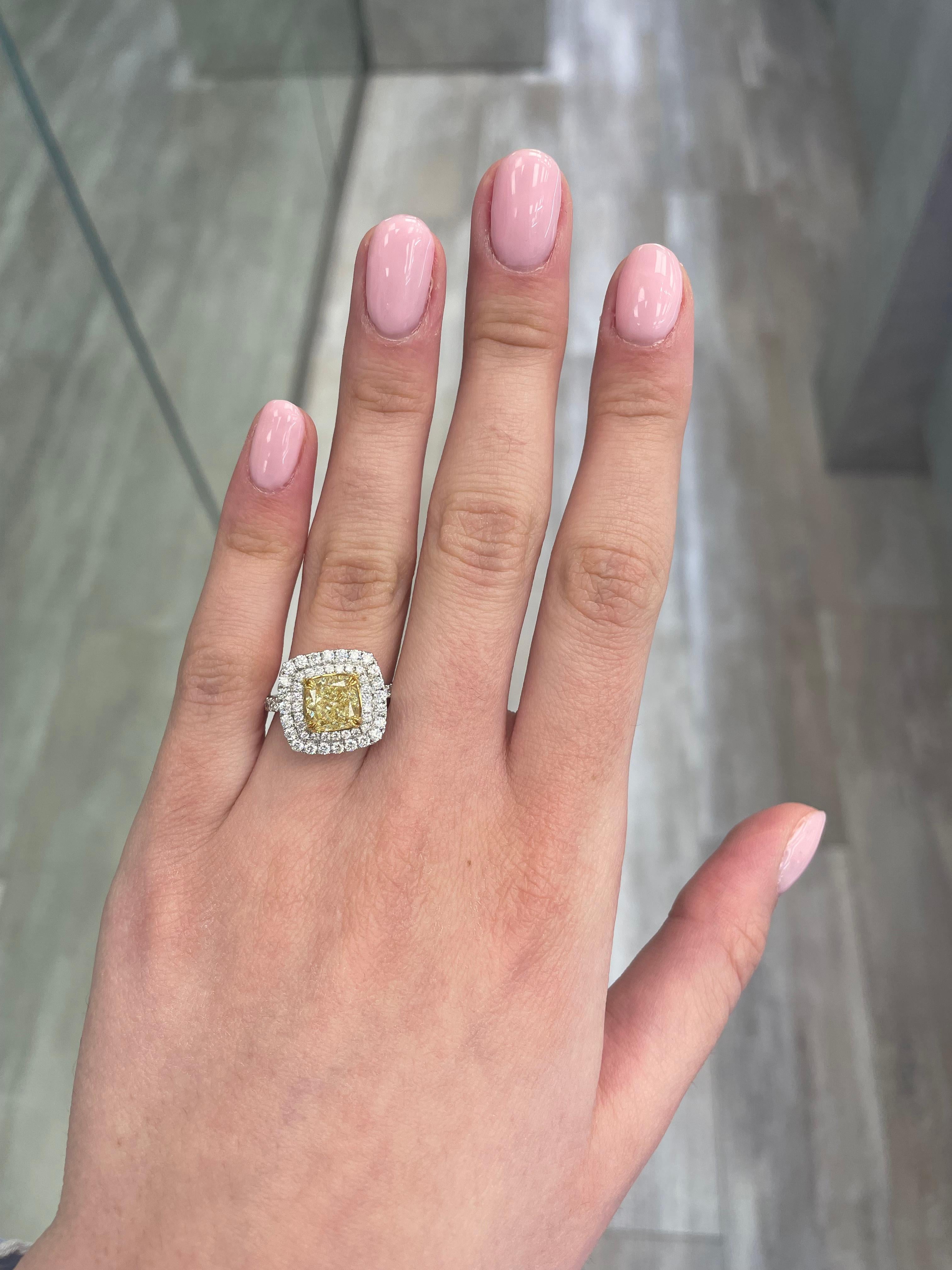 Stunning modern EGL certified yellow diamond double halo ring, two-tone 18k yellow and white gold. By Alexander Beverly Hills
2.29 carats total diamond weight.
1.52 carat cushion cut Fancy Yellow color and VS2 clarity diamond, EGL graded.