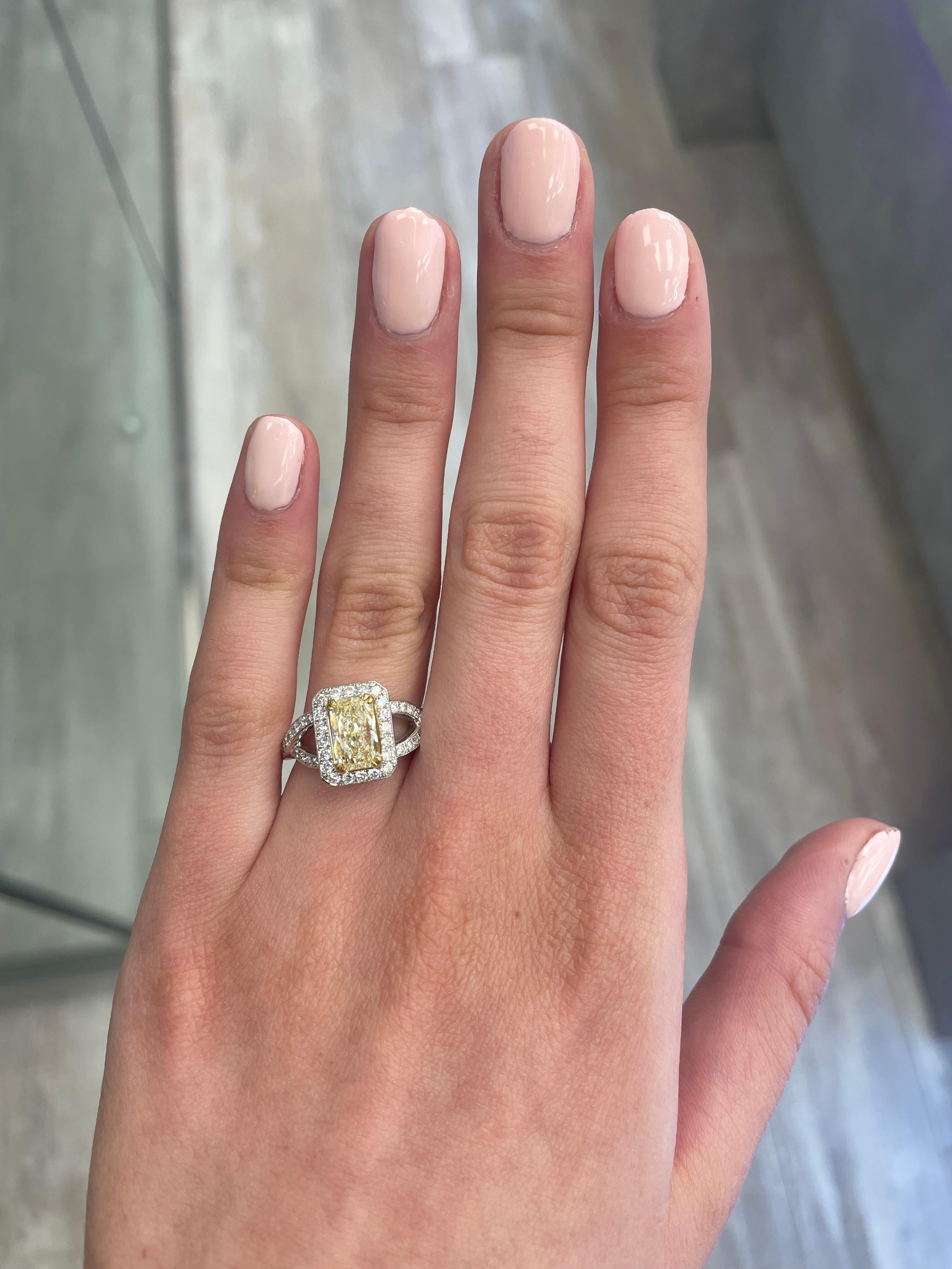 Stunning modern EGL certified yellow diamond with halo ring, two-tone 18k yellow and white gold, split shank. By Alexander Beverly Hills
2.30 carats total diamond weight.
1.55 carat radiant cut Fancy Yellow color and VS1 clarity diamond, EGL graded.