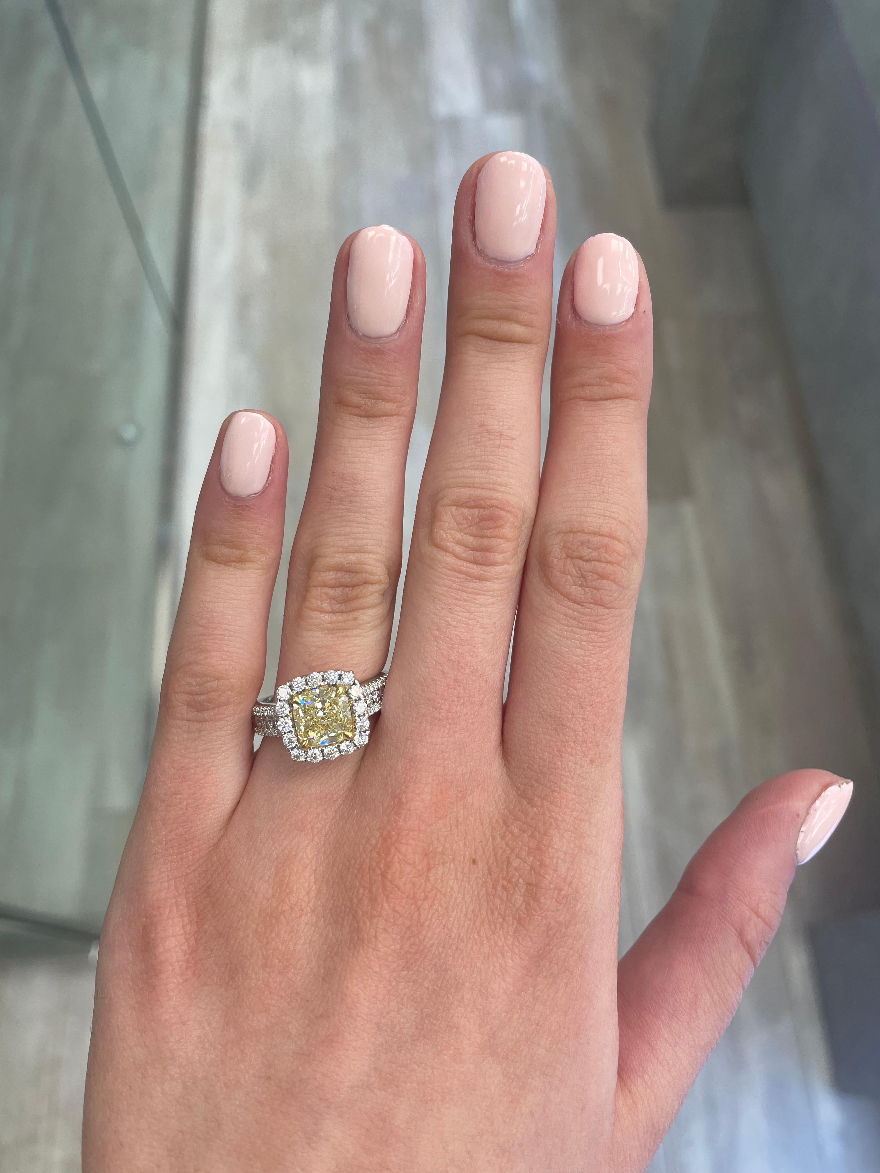 Stunning modern EGL certified yellow diamond with halo ring, two-tone 18k yellow and white gold, split shank. By Alexander Beverly Hills
3.32 carats total diamond weight.
2.38 carat cushion cut Fancy Yellow color and SI1 clarity diamond, EGL graded.