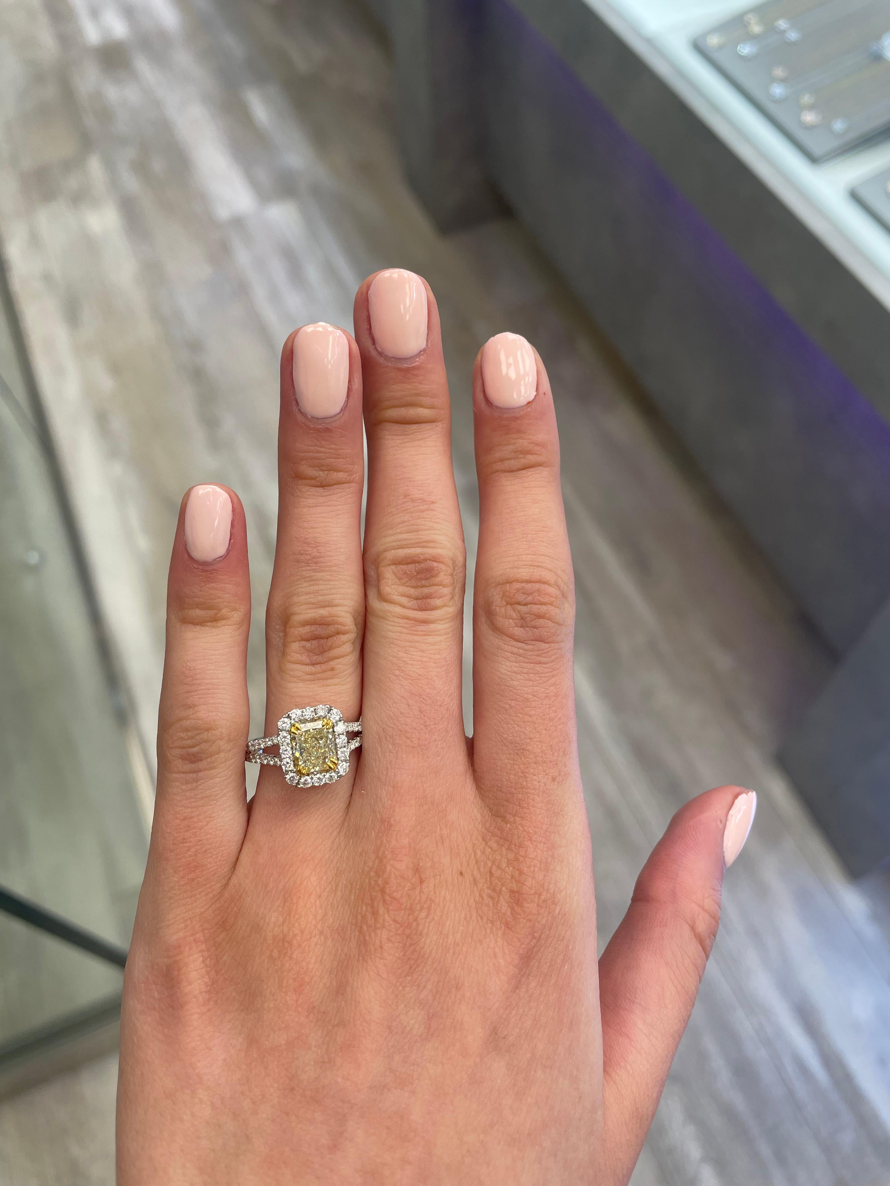 Stunning modern EGL certified yellow diamond with halo ring, two-tone 18k yellow and white gold, split shank. By Alexander Beverly Hills
2.42 carats total diamond weight.
1.75 carat radiant cut Fancy Light Yellow color and SI1 clarity diamond, EGL