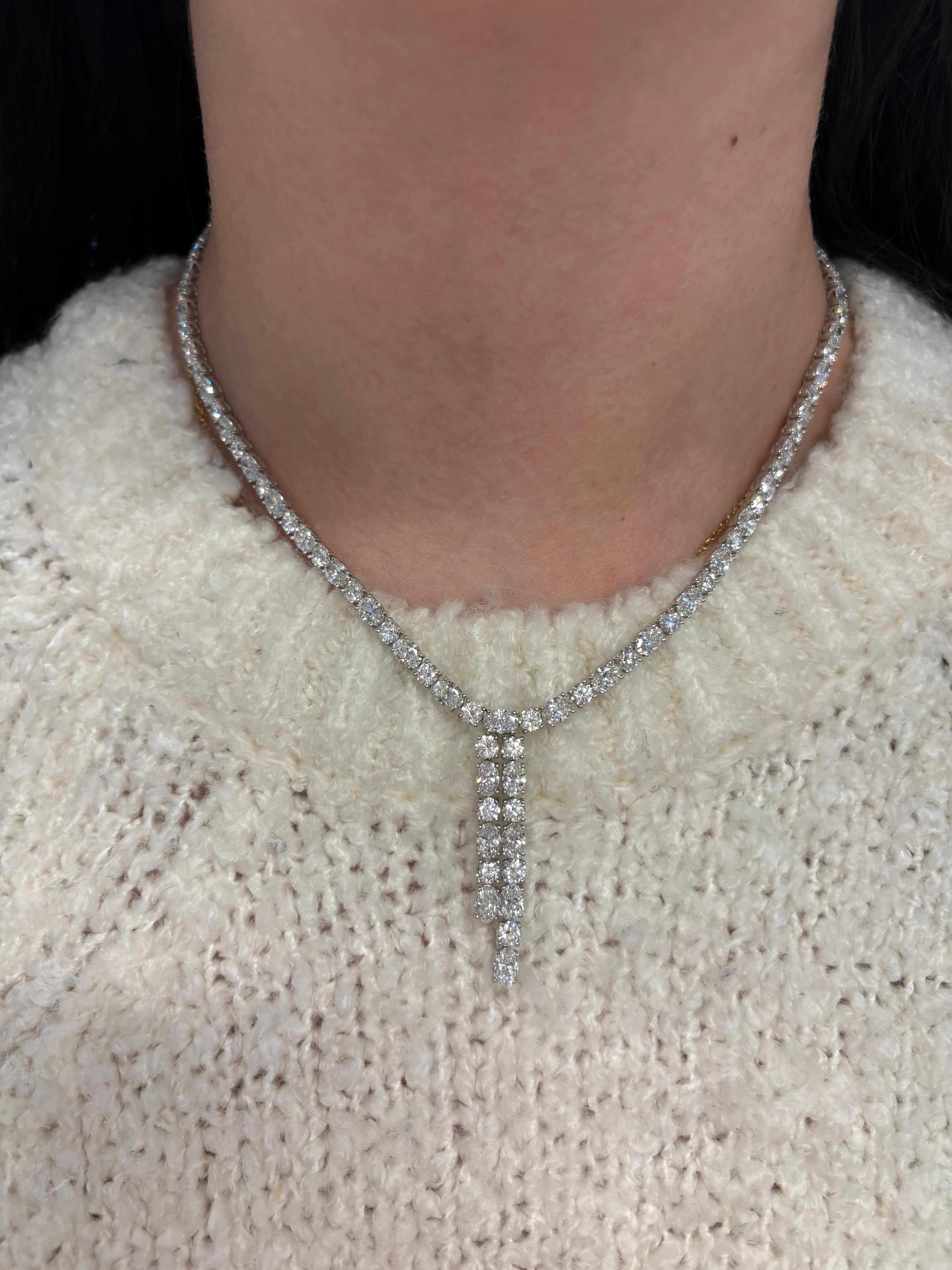 Exquisite diamond bow motif drop necklace, by Alexander Beverly Hills.
25.09 carats total diamond weight.
50 oval brilliant diamonds, 15.74 carats. 50 round brilliant diamonds, 9.35 carats. Approximately G-I color and VS1-SI1 clarity. Prong set in