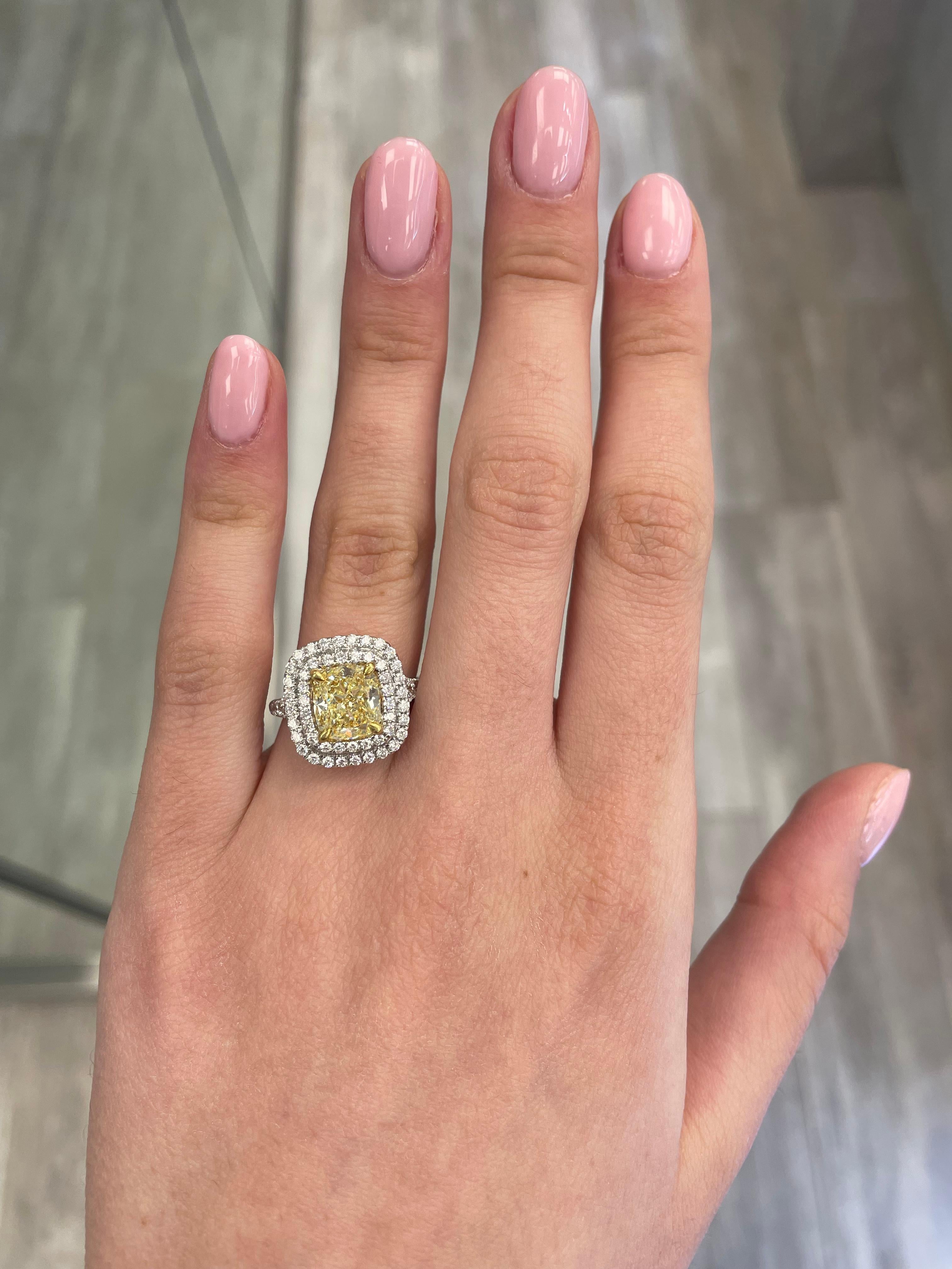 Stunning modern EGL certified yellow diamond double halo ring, two-tone 18k yellow and white gold. By Alexander Beverly Hills
3.32 carats total diamond weight.
2.50 carat cushion cut Fancy Intense Yellow color and VS1 clarity diamond, EGL graded in