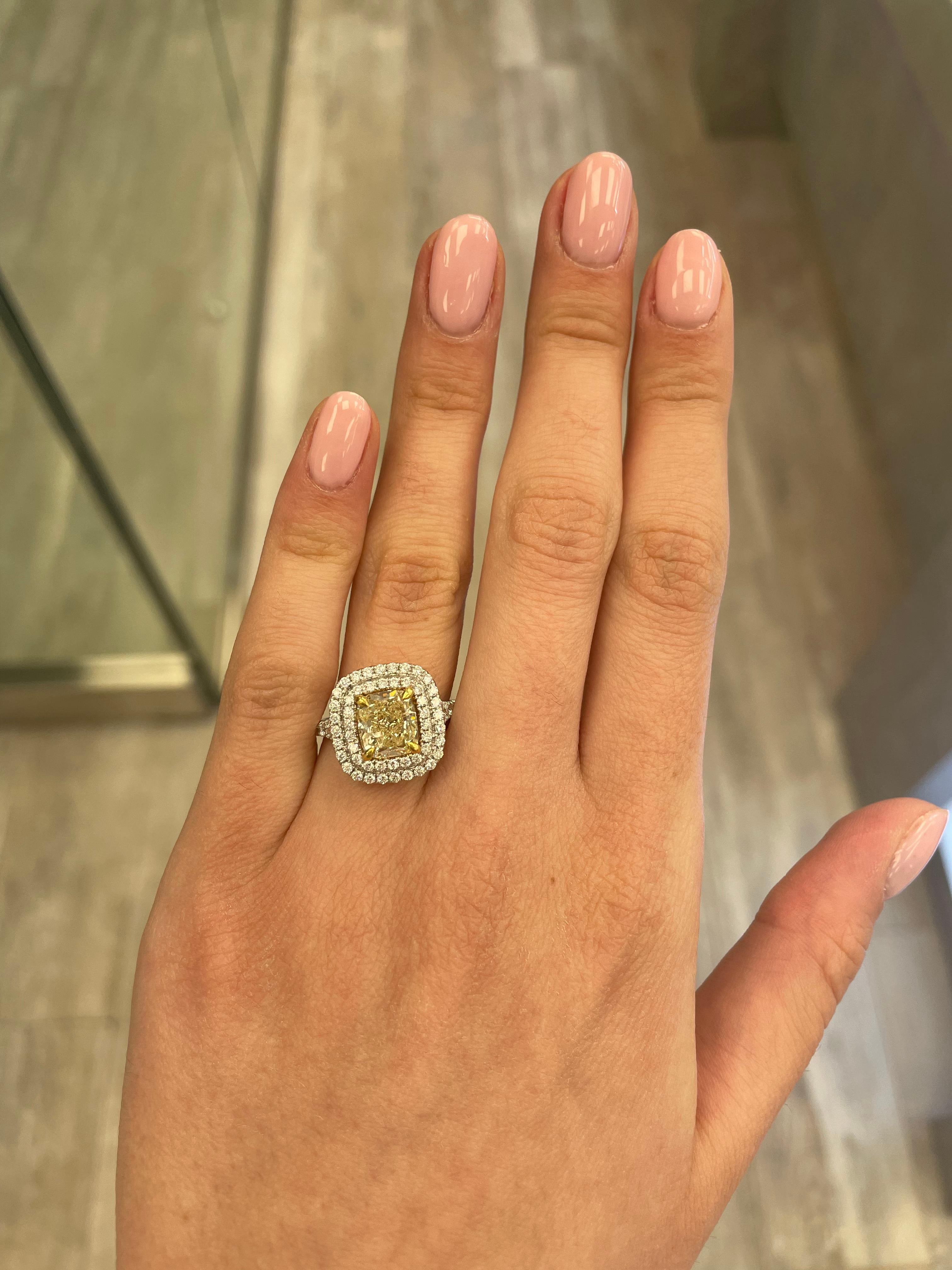 Stunning modern EGL certified yellow diamond double halo ring, two-tone 18k yellow and white gold. By Alexander Beverly Hills
3.33 carats total diamond weight.
2.51 carat cushion cut Fancy Yellow color and SI3 clarity diamond, EGL graded in the