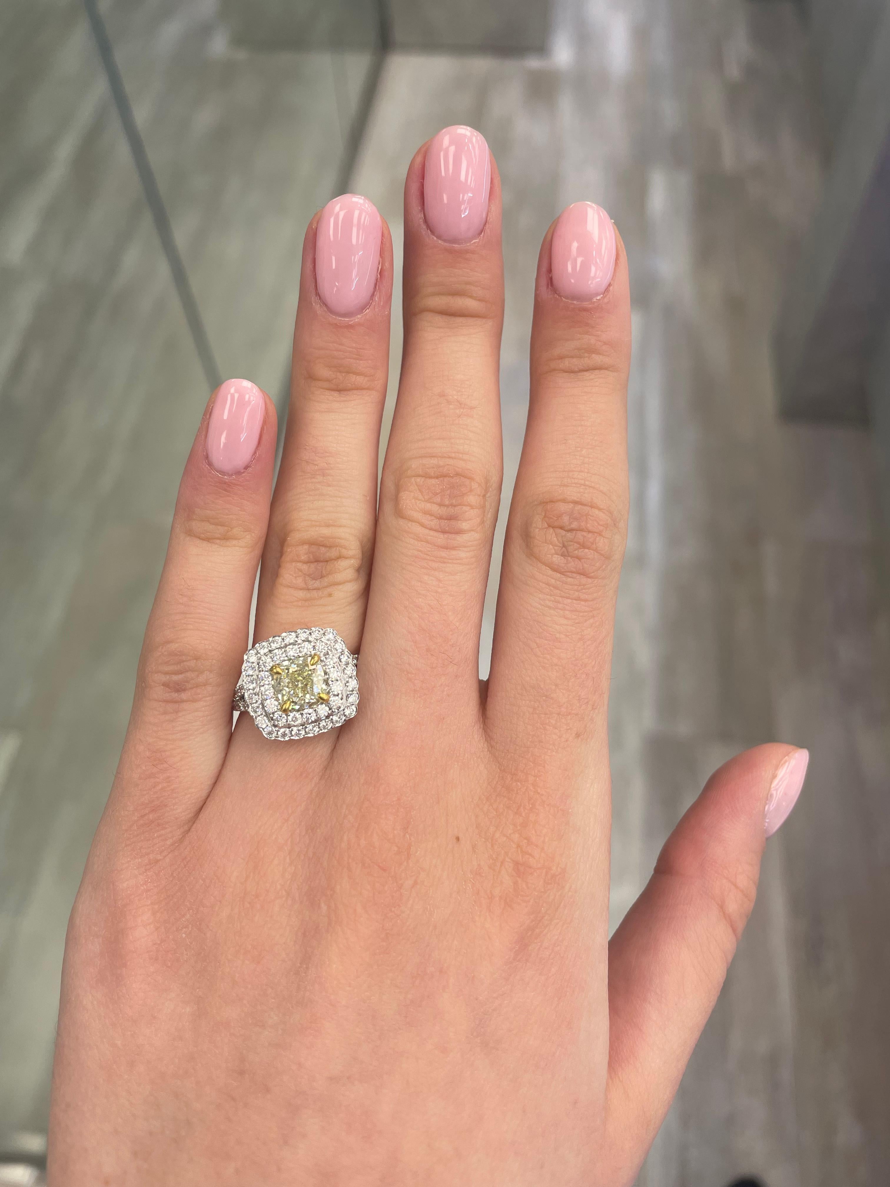 Stunning modern EGL certified yellow diamond double halo ring, two-tone 18k yellow and white gold, split shank. By Alexander Beverly Hills
2.52 carats total diamond weight.
1.52 carat cushion cut Fancy Light Yellow color and VS2 clarity diamond, EGL