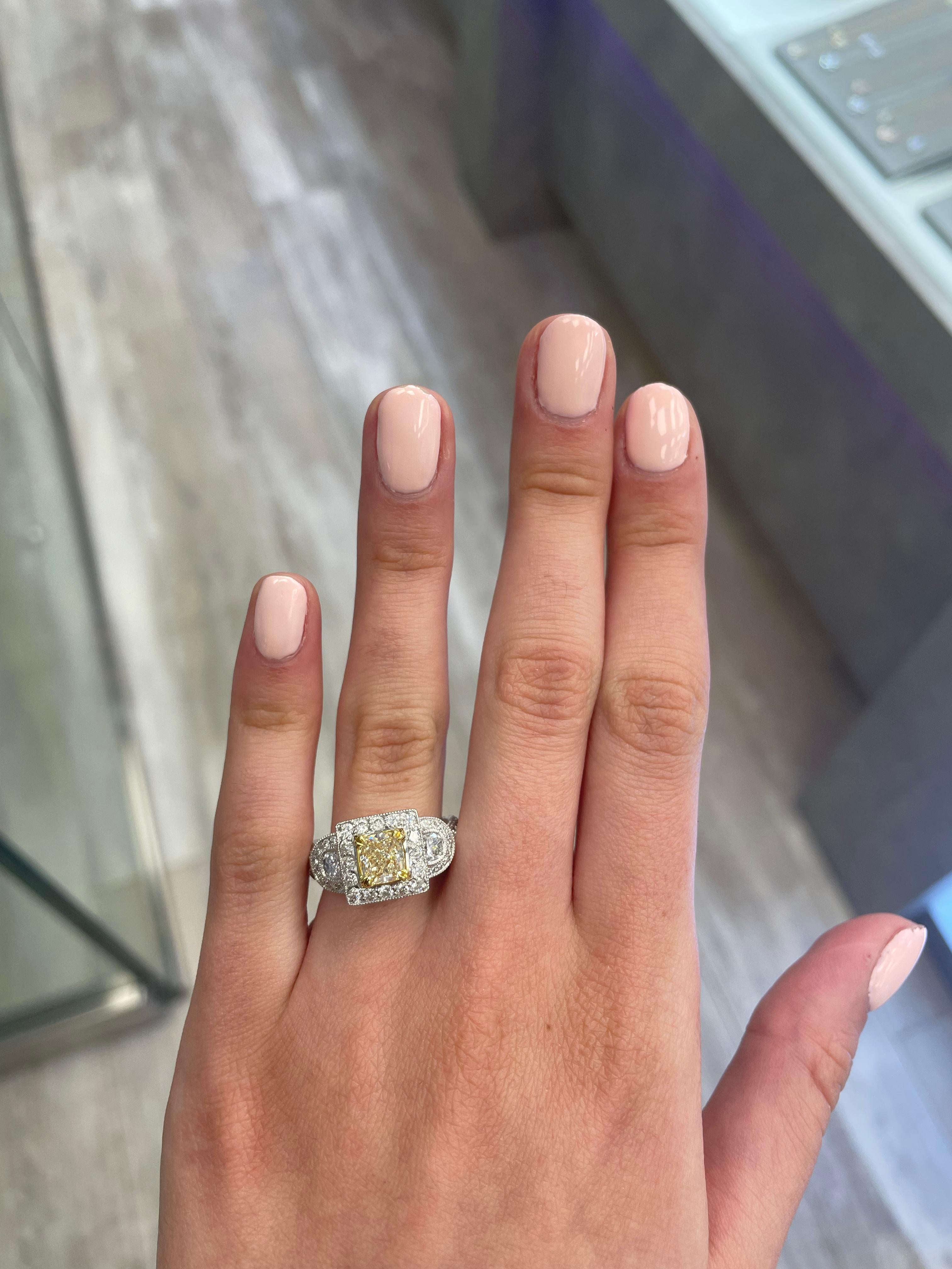 Stunning modern EGL certified yellow diamond with halo ring, two-tone 18k yellow and white gold, split shank. By Alexander Beverly Hills
2.63 carats total diamond weight.
1.13 carat cushion cut Fancy Yellow color and VVS2 clarity diamond, EGL