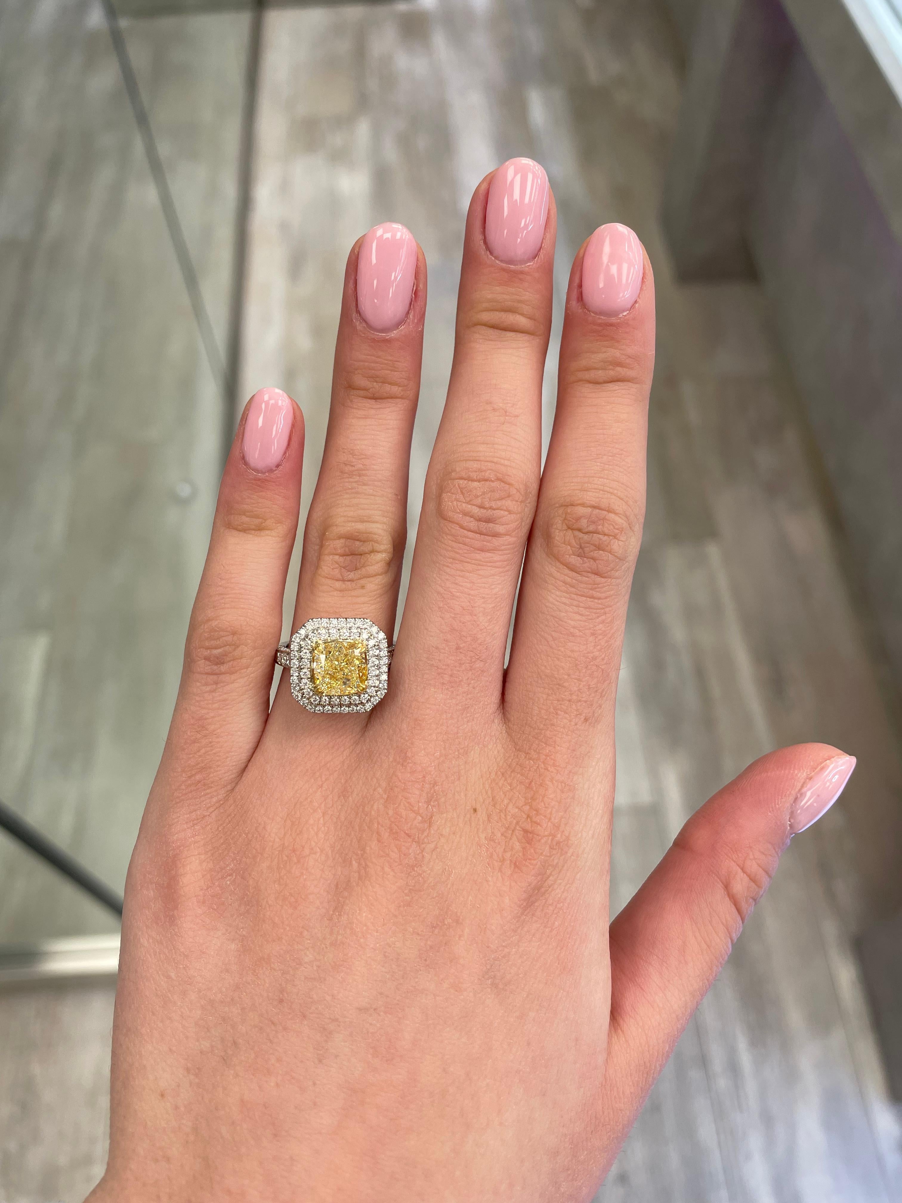 Stunning modern EGL certified yellow diamond double halo ring, two-tone 18k yellow and white gold. By Alexander Beverly Hills
3.69 carats total diamond weight.
2.71 carat cushion cut Fancy Intense Yellow color and VS2 clarity diamond, EGL graded.