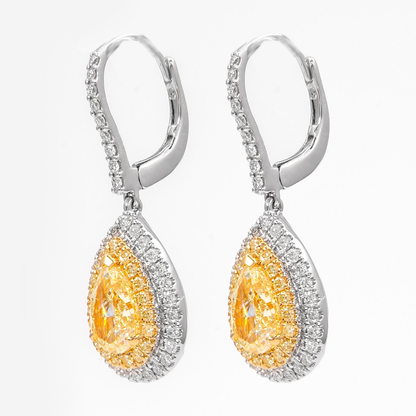Stunning yellow diamond and diamond halo drop earrings, by Alexander Beverly Hills.
2.74 carats total diamond weight.
2 pear shape diamonds, 2.01 carats total. Approximately Fancy Light Yellow color grade and SI clarity grade. 
Complimented by 39