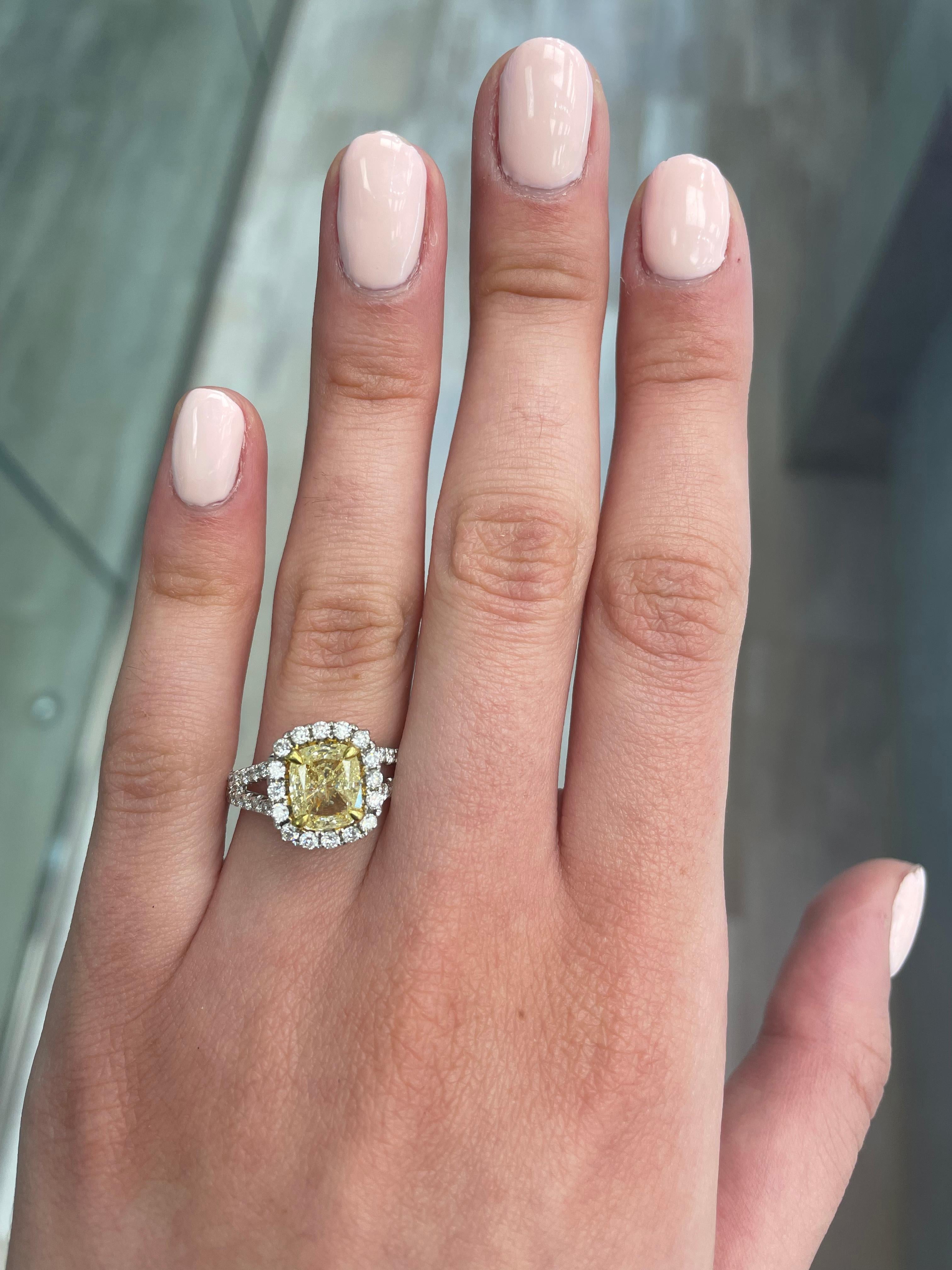 Stunning modern EGL certified yellow diamond with halo ring, two-tone 18k yellow and white gold, split shank. By Alexander Beverly Hills
2.75 carats total diamond weight.
2.02 carat cushion cut Fancy Yellow color and SI3 clarity diamond, EGL graded.