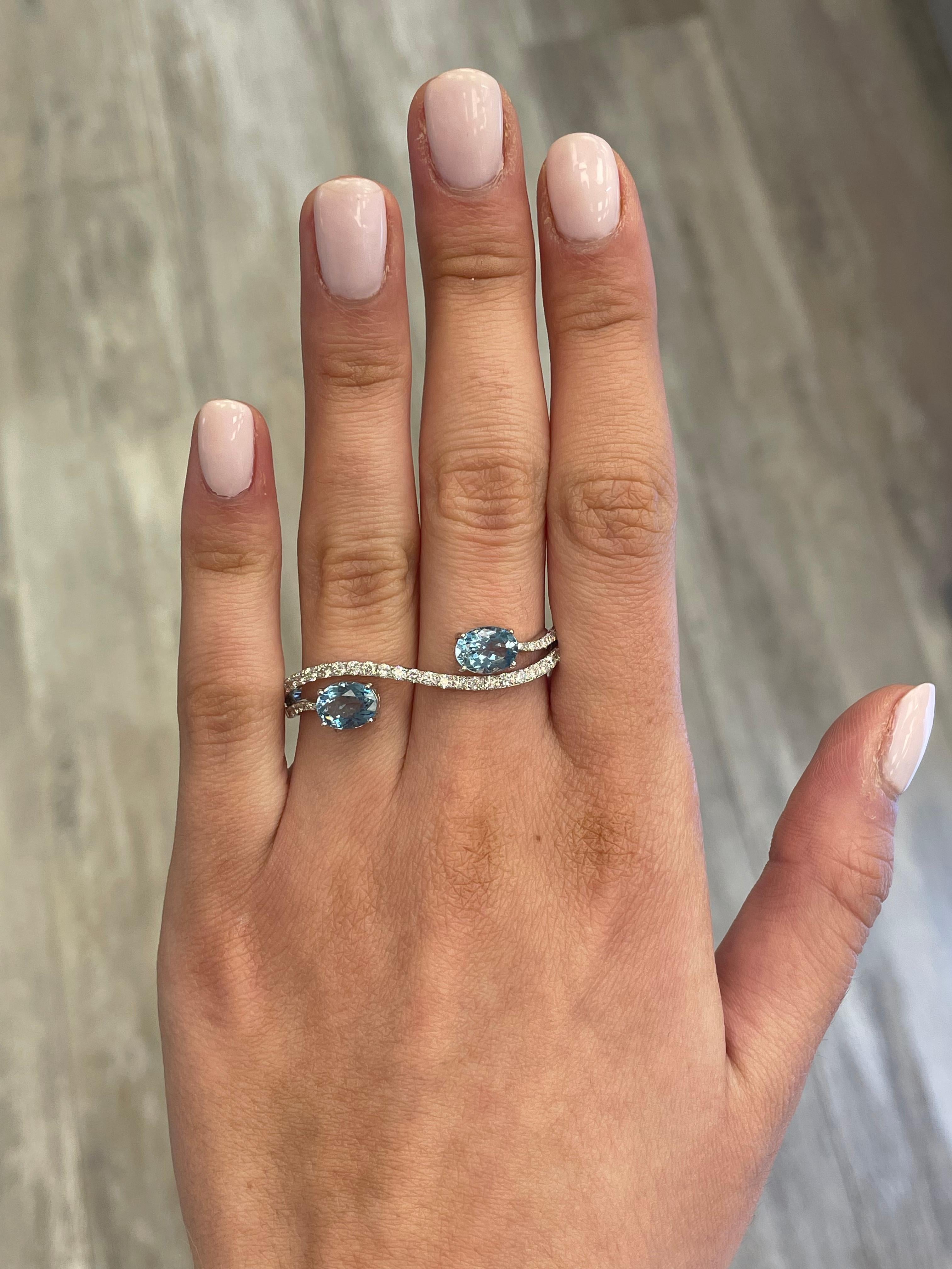 Stunning aquamarine and diamond double ring, by Alexander Beverly Hills.
2 oval aquamarines, 2.20 carats. Complimented by 37 round brilliant diamonds, 0.67 carats. Approximately D-F color and SI clarity. 18-karat white gold, 5.53 grams, 6.5 & 6.75