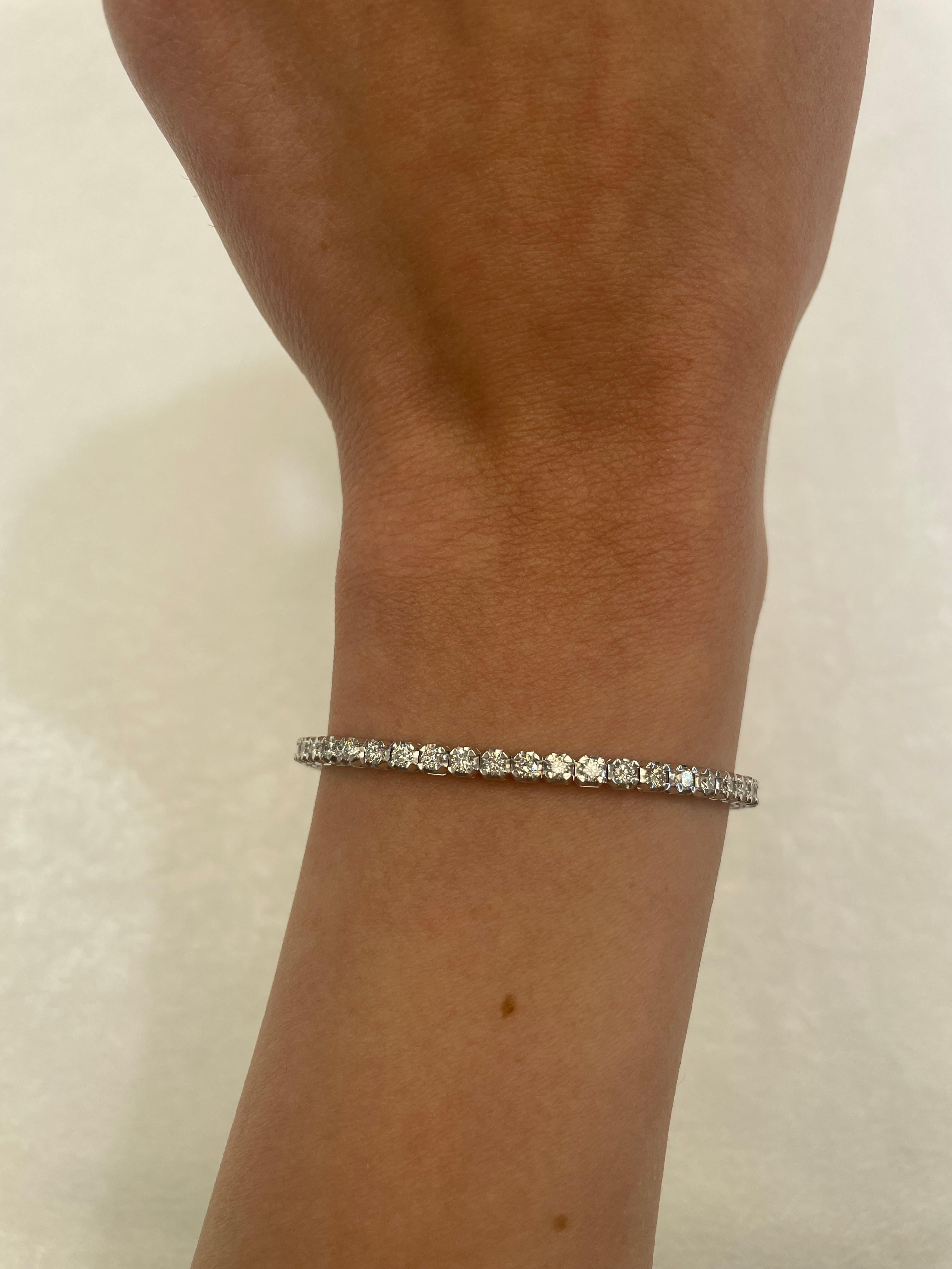 Exquisite and timeless diamonds tennis bracelet, by Alexander Beverly Hills.
55 round brilliant diamonds, 2.96 carats total. Approximately D/E color and VS2/SI1 clarity. Four prong set in 18k white gold, 9.68 grams, 7 inches. 
Accommodated with an