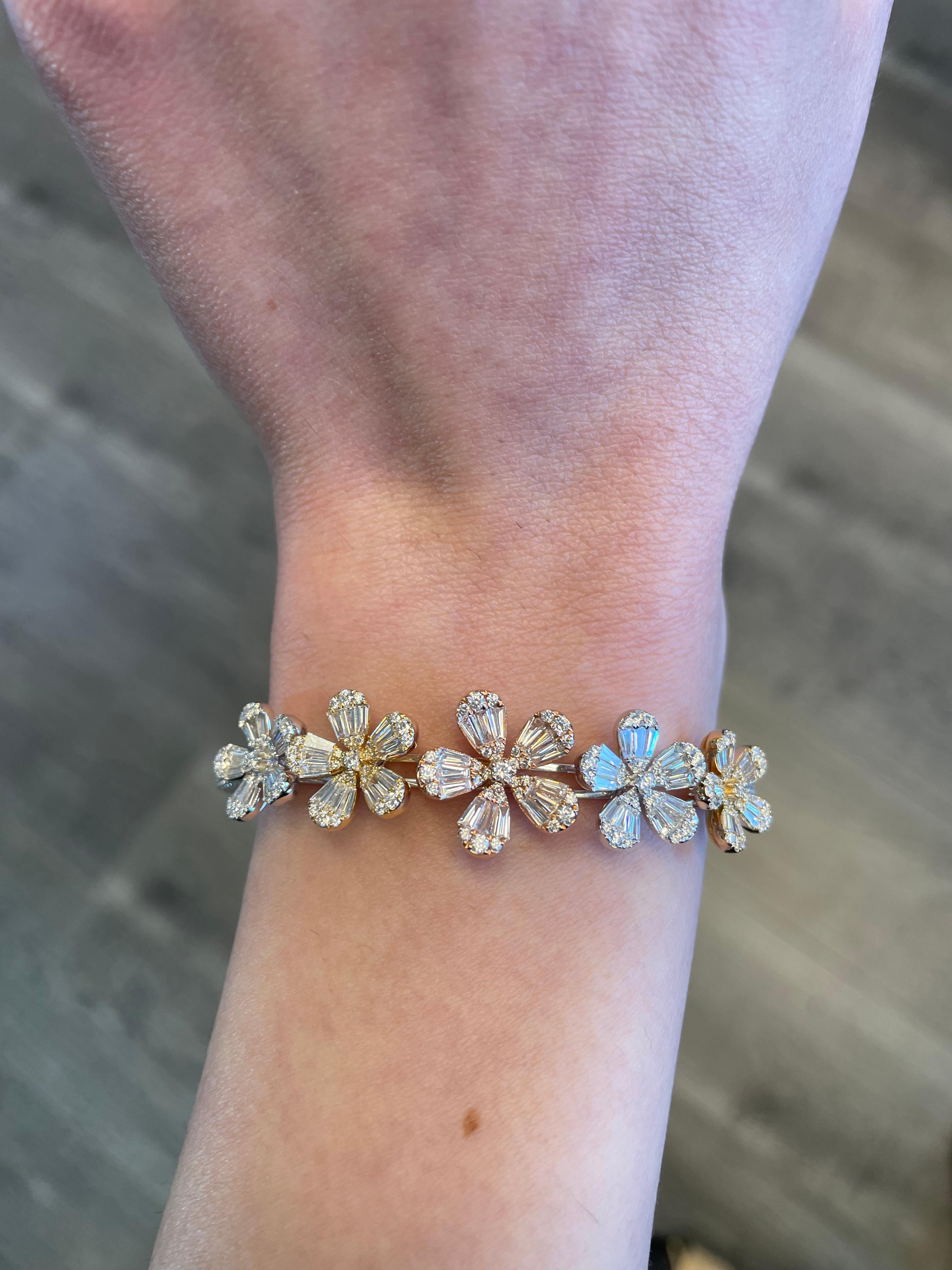 Exquisite modern diamond floral bangle, illusion set. By Alexander Beverly Hills.
263 tapered baguette and round cut diamonds, 3.01 carats. Approximately G/H color and VS clarity. 14.49 grams 18-karat white, yellow, and rose gold. 
Accommodated with