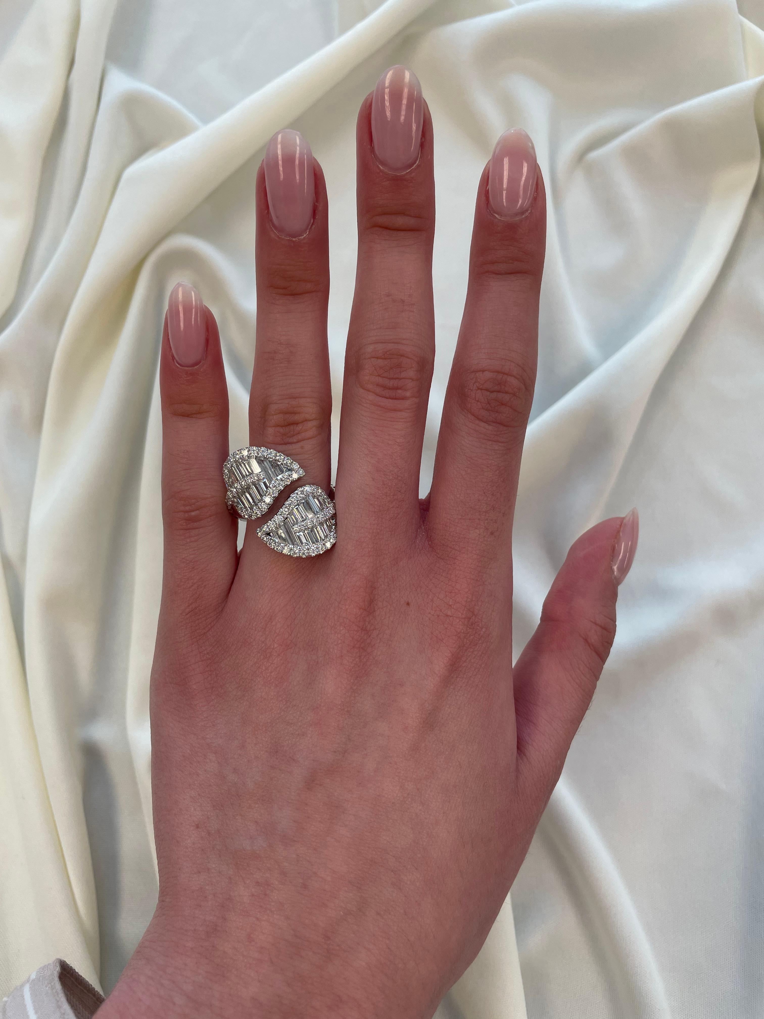 Stunning modern leaf motif bypass ring, by Alexander Beverly Hills.
100 round and baguette cut diamonds, 3.23 carats. Approximately G/H color grade and VS clarity grade. 18-karat white gold, 10.17 grams, current ring size 7.
Accommodated with an