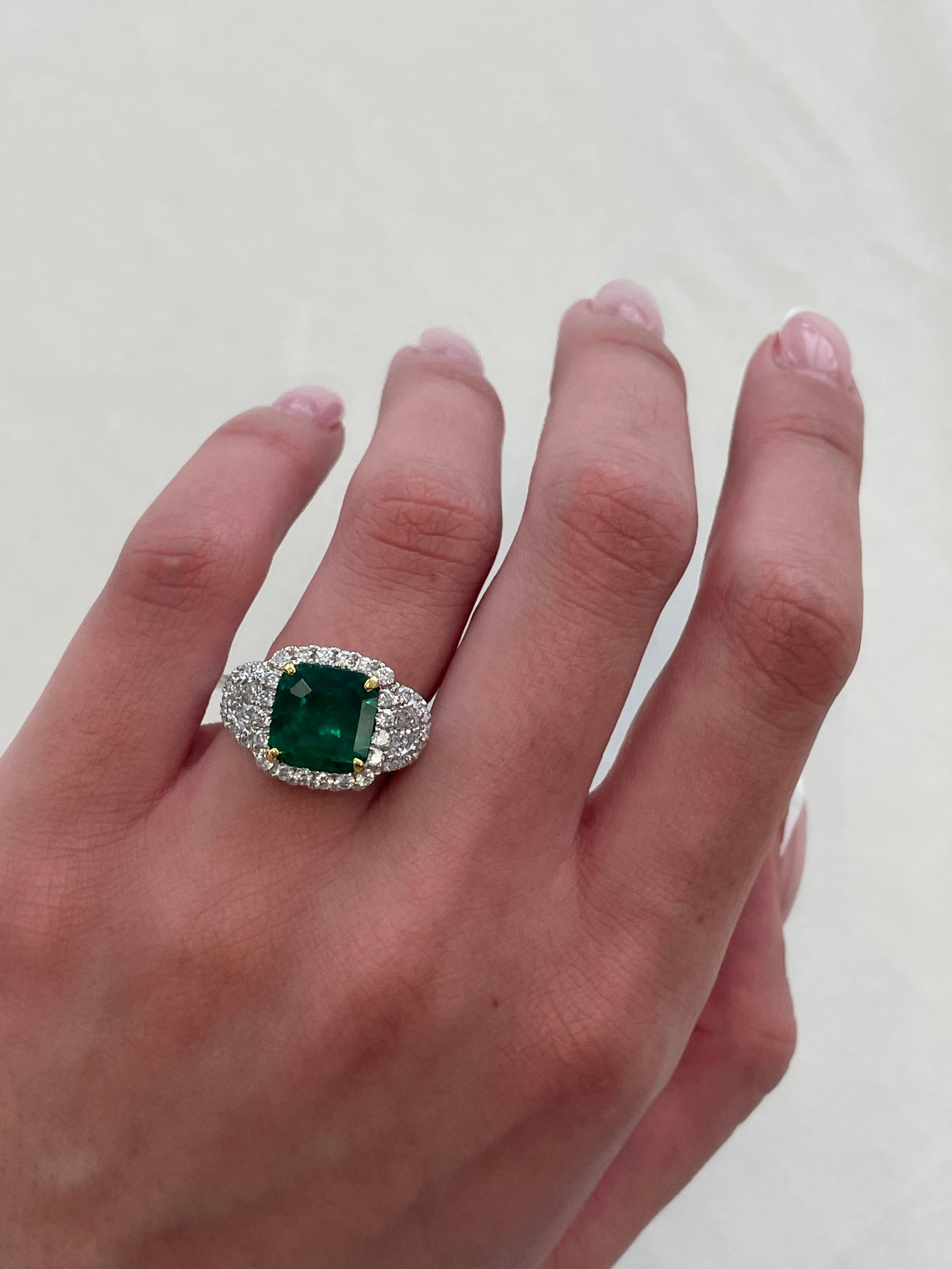 Stunning emerald and diamond three stone ring with halo. By Alexander of Beverly Hills. 
Superb color.
3.26 carats total gemstone weight.
1.97 carat square emerald cut emerald. 2 half moons with 42 round brilliant diamonds, 1.29 carats.