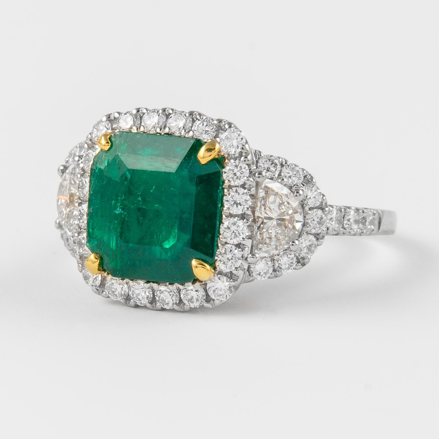 Contemporary Alexander 3.26 Carat Emerald with Diamond Three Stone Halo Ring 18 Karat Gold For Sale