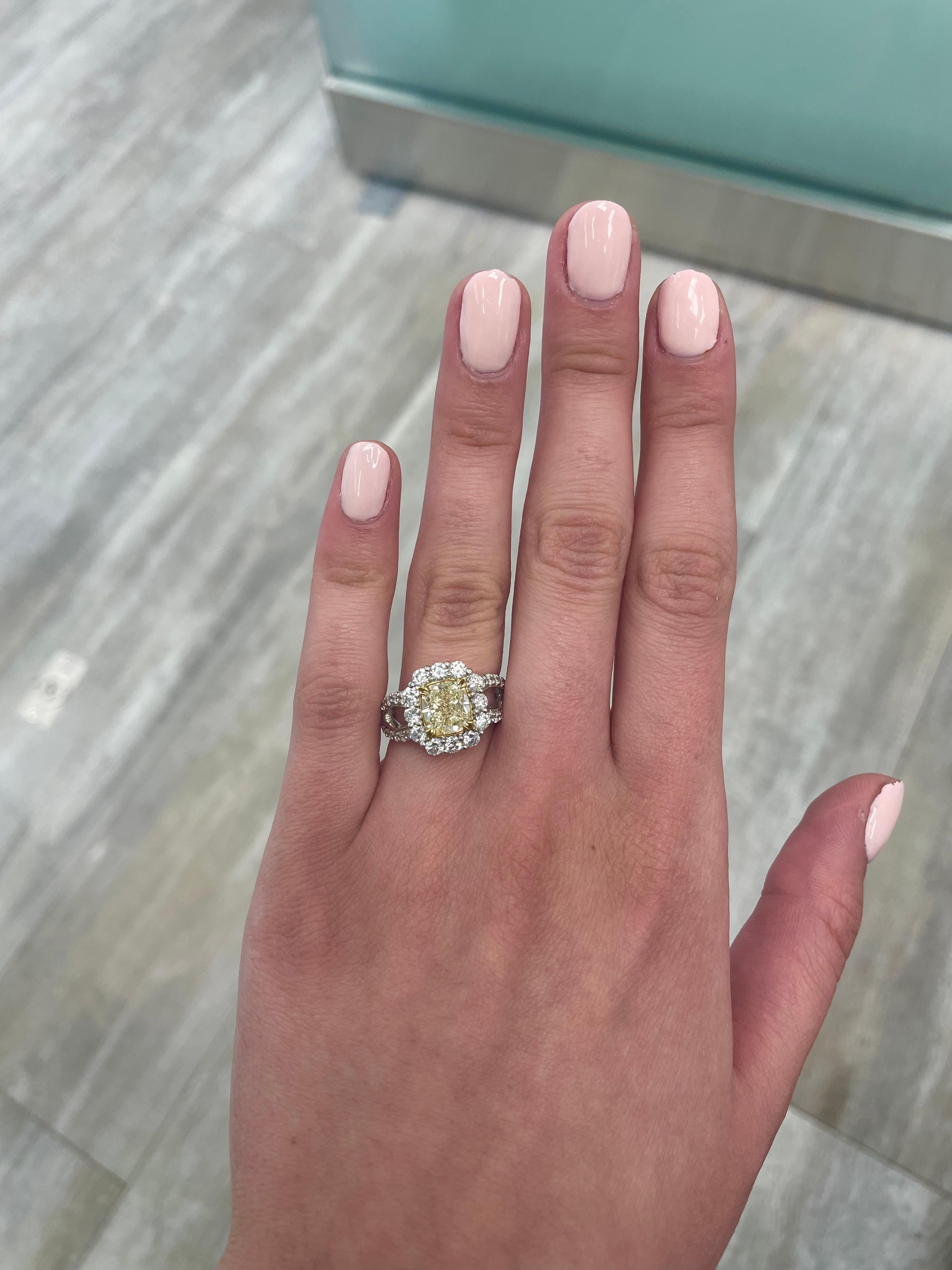Stunning modern EGL certified yellow diamond with halo ring, two-tone 18k yellow and white gold, split shank. By Alexander Beverly Hills
3.34 carats total diamond weight.
2.01 carat cushion cut Fancy Yellow color and SI2 clarity diamond, EGL graded.