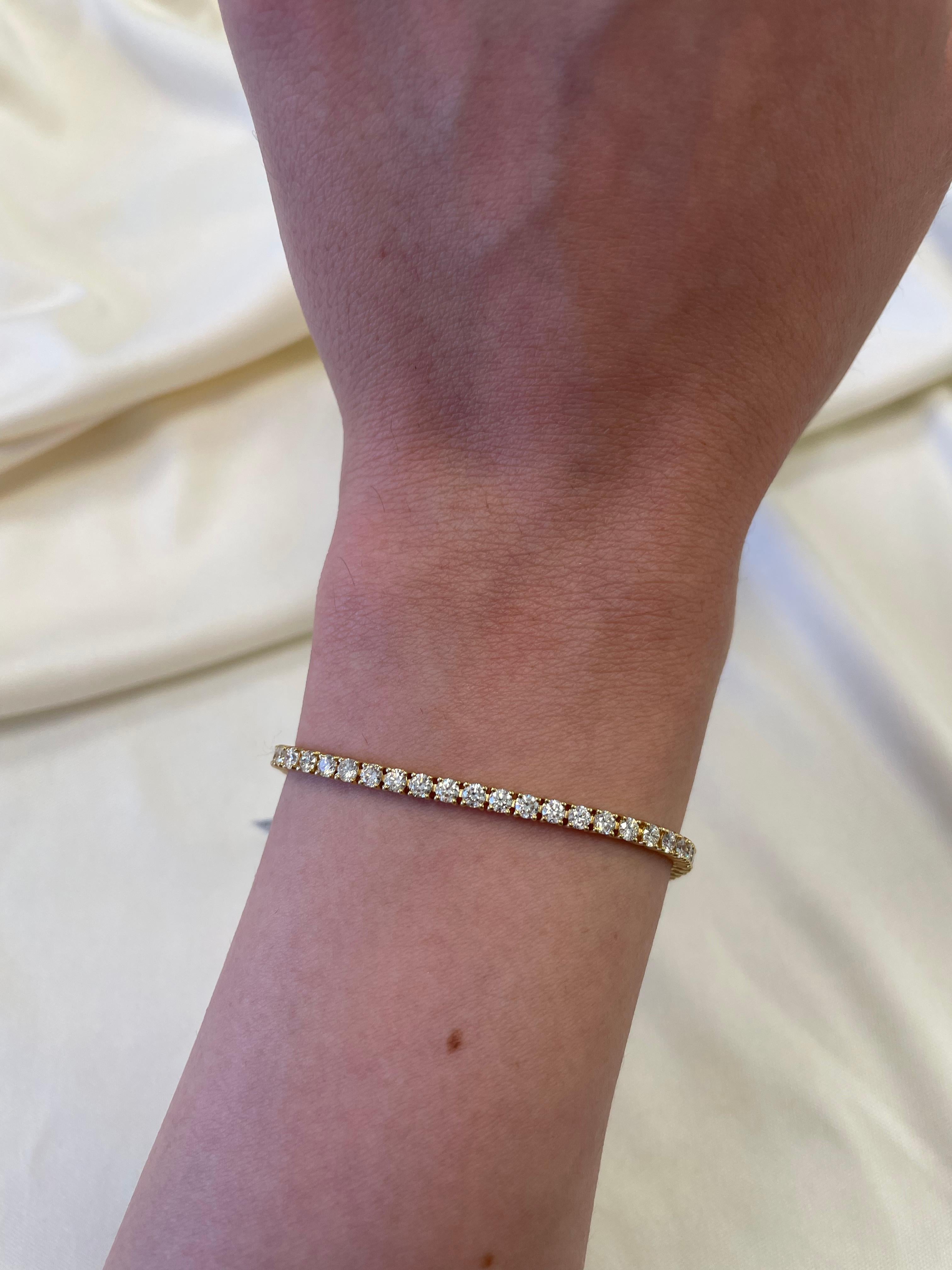 Exquisite and timeless diamonds tennis bracelet, by Alexander Beverly Hills.
65 round brilliant diamonds, 3.63 carats total. Approximately H/I color and VS clarity. Four prong set in 18k yellow gold, 8.49 grams, 7 inches. 
Accommodated with an