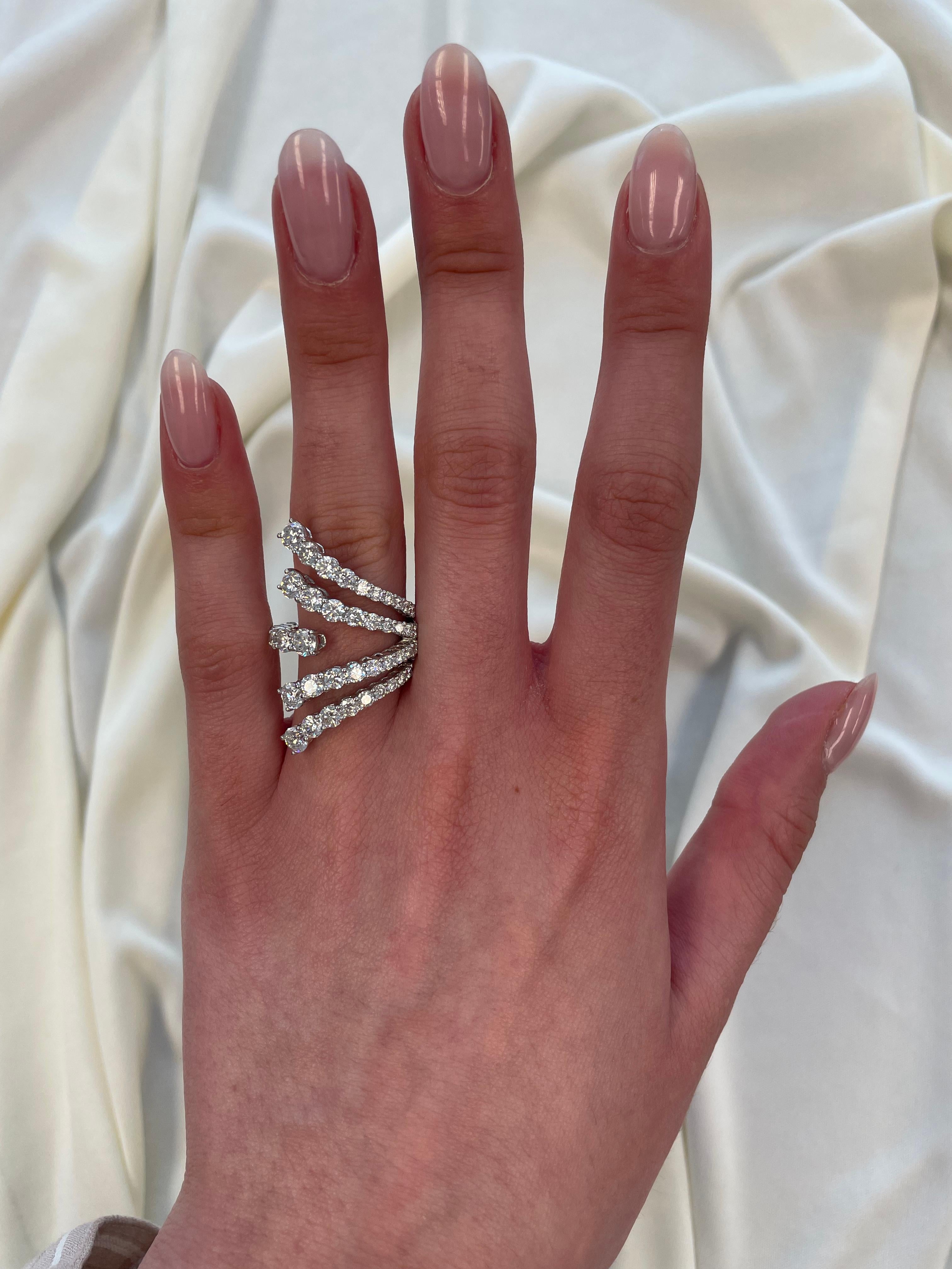 Stunning modern and unique open shank floating diamond ring. By Alexander of Beverly Hills.
46 round brilliant cut diamonds, 3.76 carats. Approximately G/H color and SI clarity. 18-karat white gold, 7.77 grams, current ring size 7.
Accommodated with