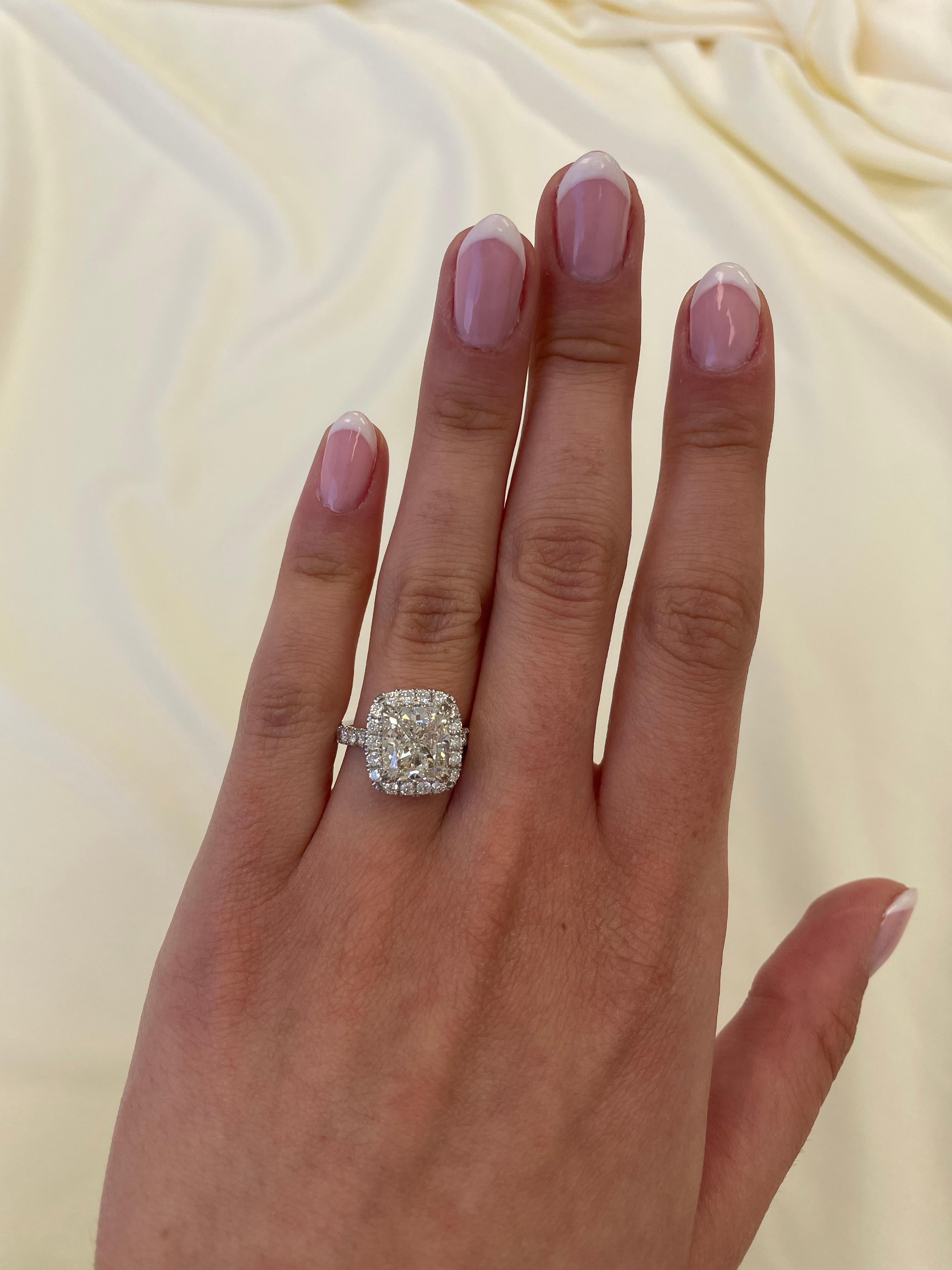 Classic stunning diamond engagement ring with diamond halo, EGL certified. By Alexander Beverly Hills.
4.47 carats total diamond weight.
4.01 carat cushion diamond, EGL certified H color grade and VS1 clarity grade. Complimented by 0.46 carats of