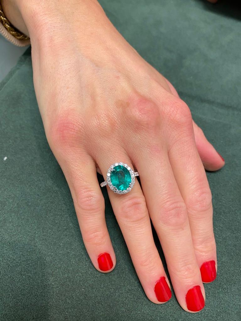 Lovely emerald with diamond halo ring. By Alexander Beverly Hills.
4.05 carat oval emerald apx F2 complimented with 32 round brilliant diamonds, 1.01ct. Approximately H/I color and SI clarity. 5.06ct total gemstone weight, in 18k white gold.