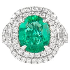 Alexander 4.36ctt Emerald with Diamond Three Stone Halo Ring 18 Karat Gold Alexander 4.36ctt Emerald with Diamond Three Stone Halo Ring 18 Karat Gold