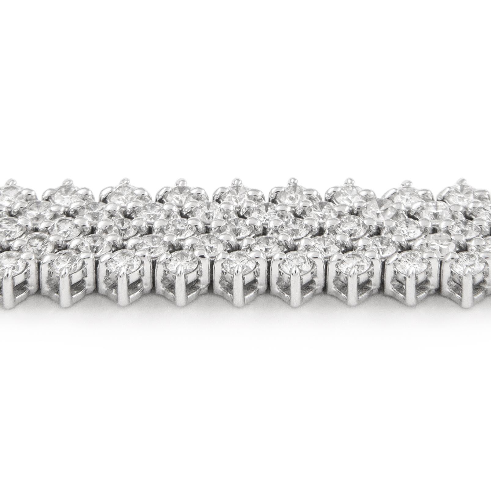 Exquisite and timeless five row diamonds tennis bracelet, by Alexander Beverly Hills.
345 diamonds total, 4.55 carats total. Approximately F/G color and VS2/SI1 clarity. 18.86 grams, 18k white gold, 7 inches. 
Accommodated with an up-to-date