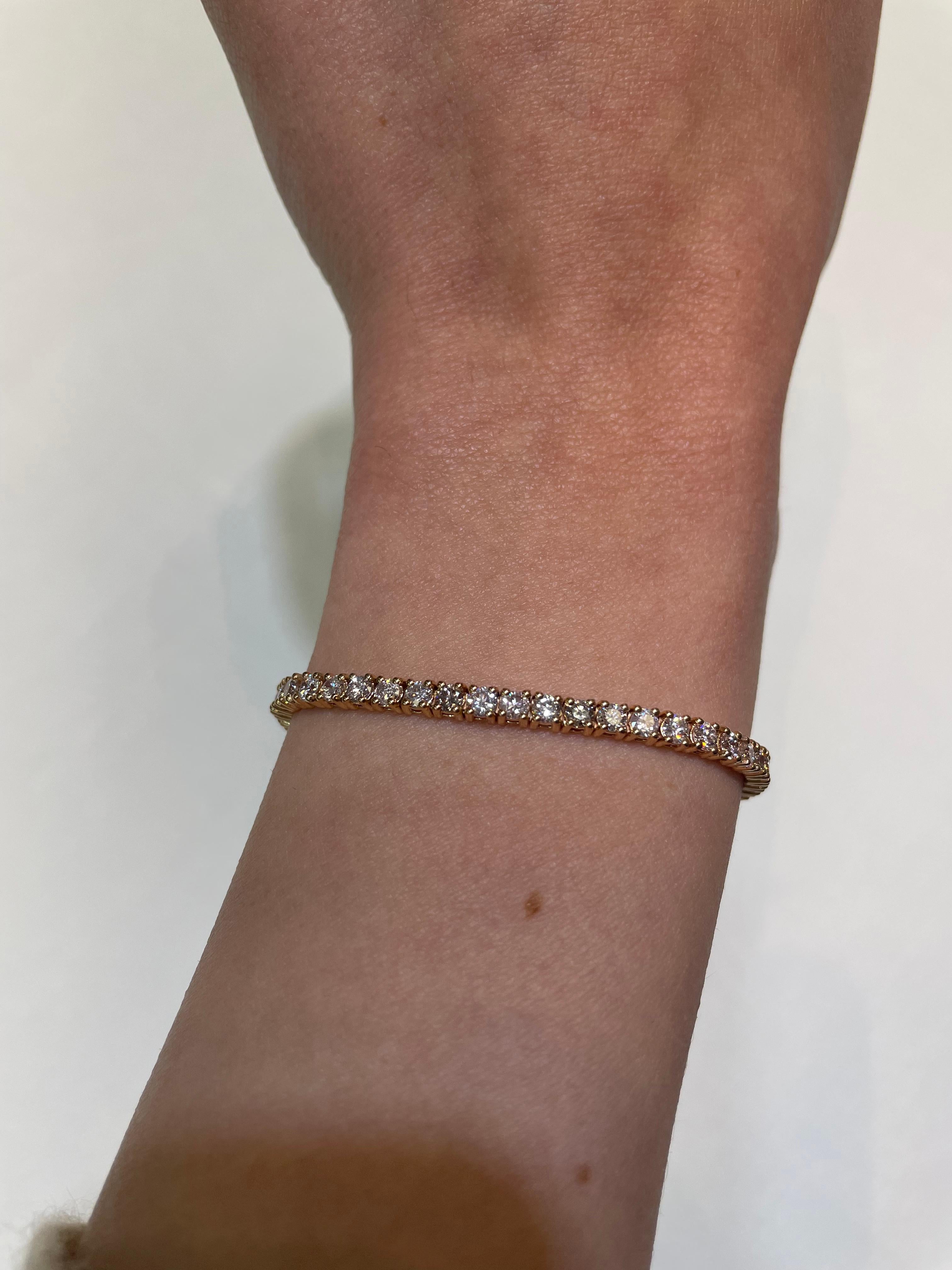 Exquisite and timeless diamonds tennis bracelet, by Alexander Beverly Hills.
60 round brilliant diamonds, 4.62 carats total. Approximately Very Light Pink color (looks like regular white diamonds in mounting) and SI clarity. Four prong set in 14k