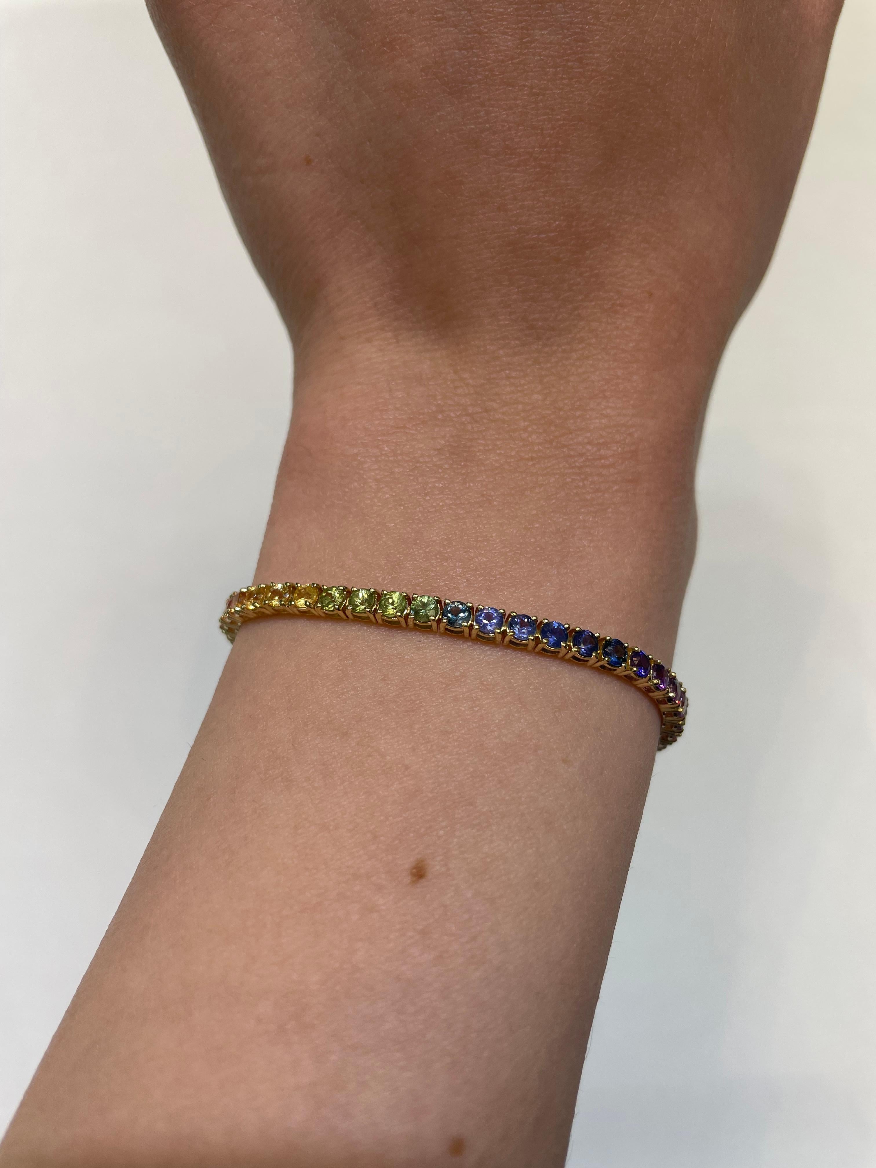 Exquisite and perfectly graduated rainbow multi color sapphire tennis bracelet, by Alexander Beverly Hills.
57 round sapphires, 5.65 carats total. Four prong set in 18k yellow gold, 8.40 grams, 7 inches.
Accommodated with an up to date appraisal by