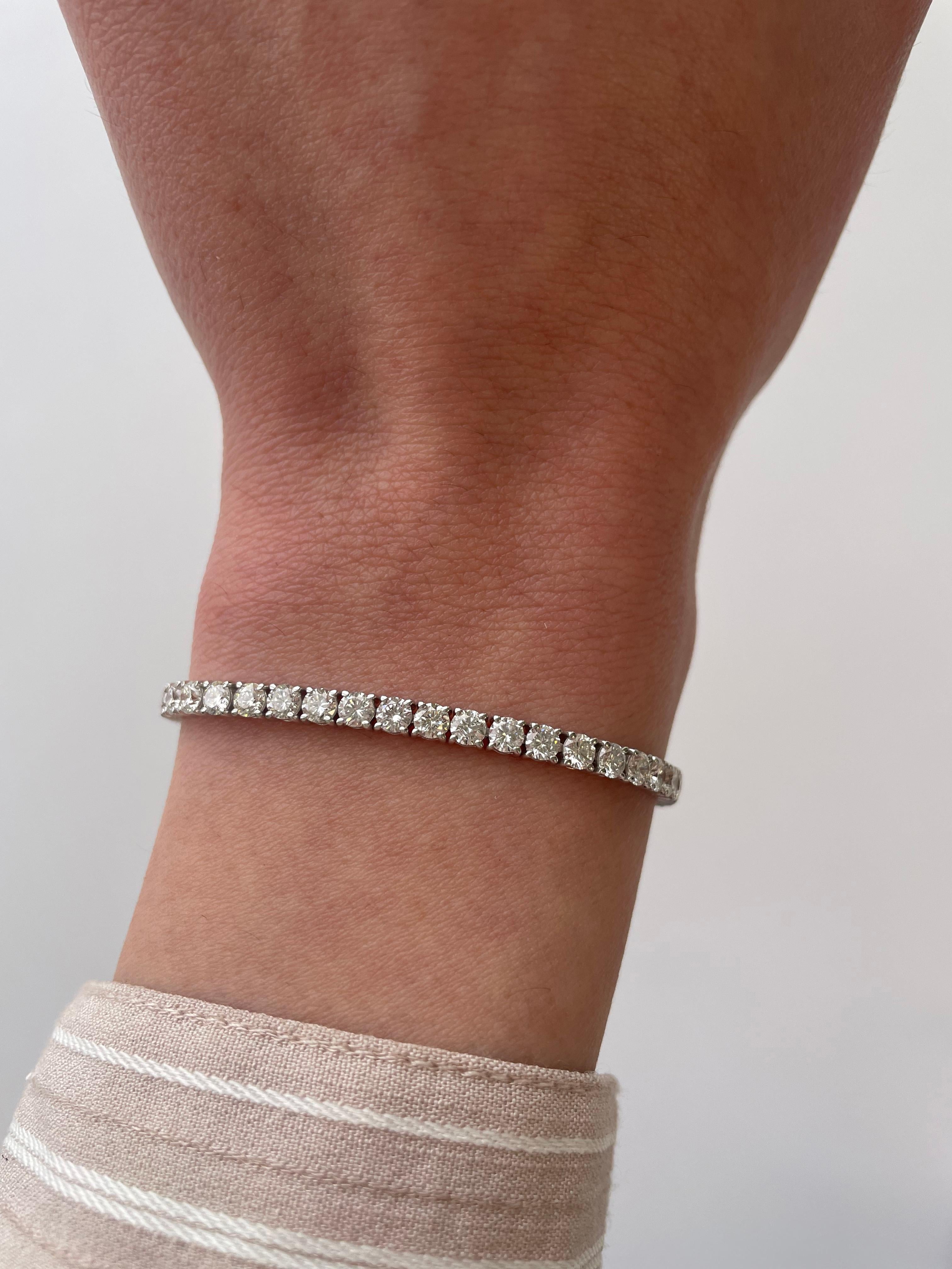 Exquisite and timeless diamonds tennis bracelet, by Alexander Beverly Hills.
53 round brilliant diamonds, 6.45 carats. Approximately D-F color and SI clarity. Four prong set in 18k white gold, 8.42 grams, 7 inches. 
Accommodated with an up-to-date