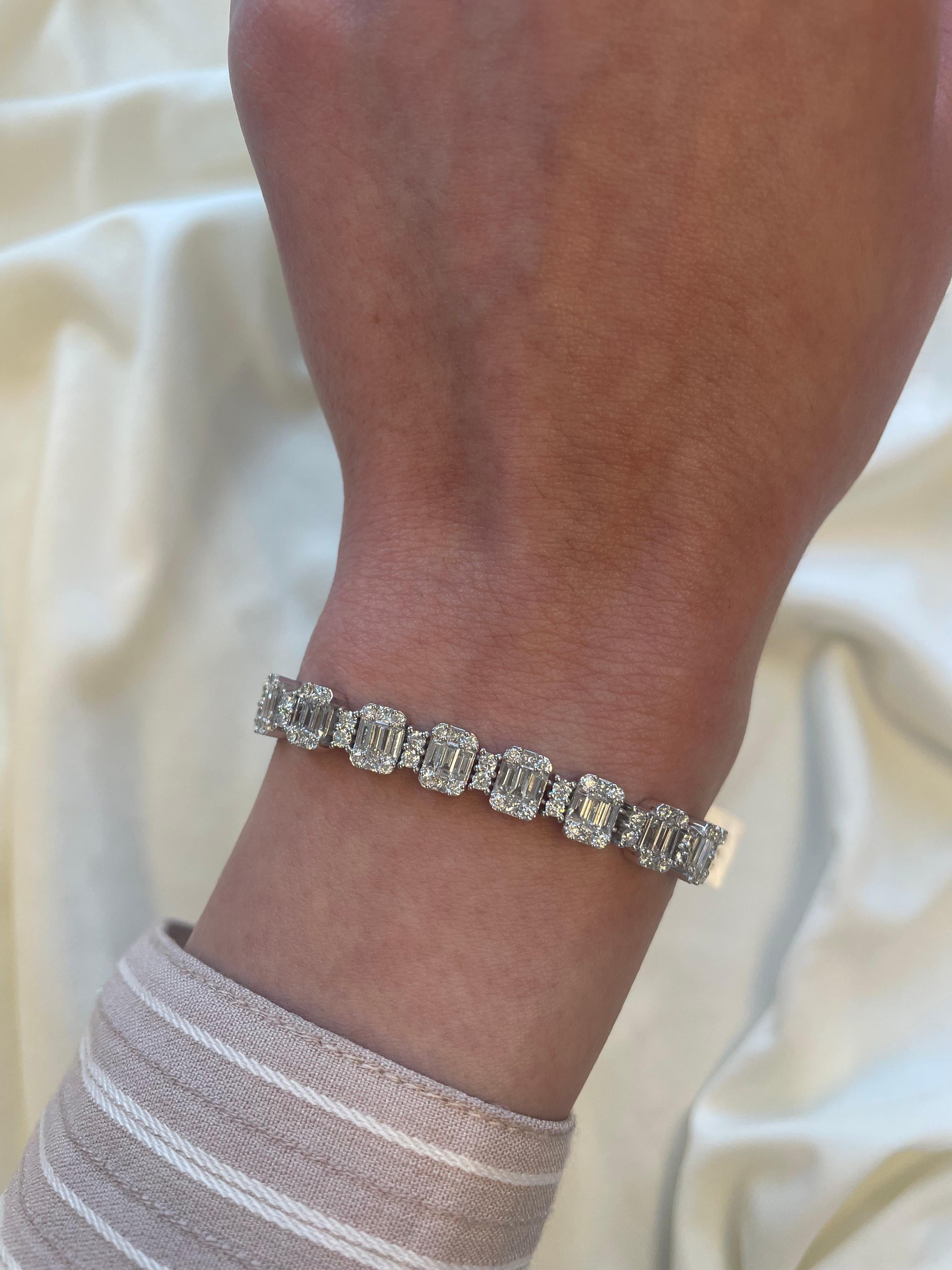 Sensational illusion set diamond bracelet with the look of emerald cut diamonds. High jewelry by Alexander Beverly Hills.
253 round, baguette, and princess cut diamonds, 7.93 carats. Approximately G/H color and VS2/SI1 clarity. 18k white gold, 23.03