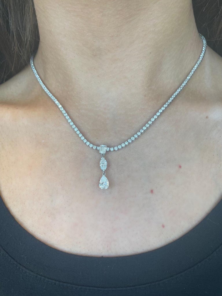 Exquisite and timeless round diamond tennis necklace with dangling emerald cut, marquise, and pear brilliant diamond. High jewelry by Alexander Beverly Hills.
176 diamonds, 8.30 carats total. 1 pear brilliant, approximately G/H color and SI clarity.