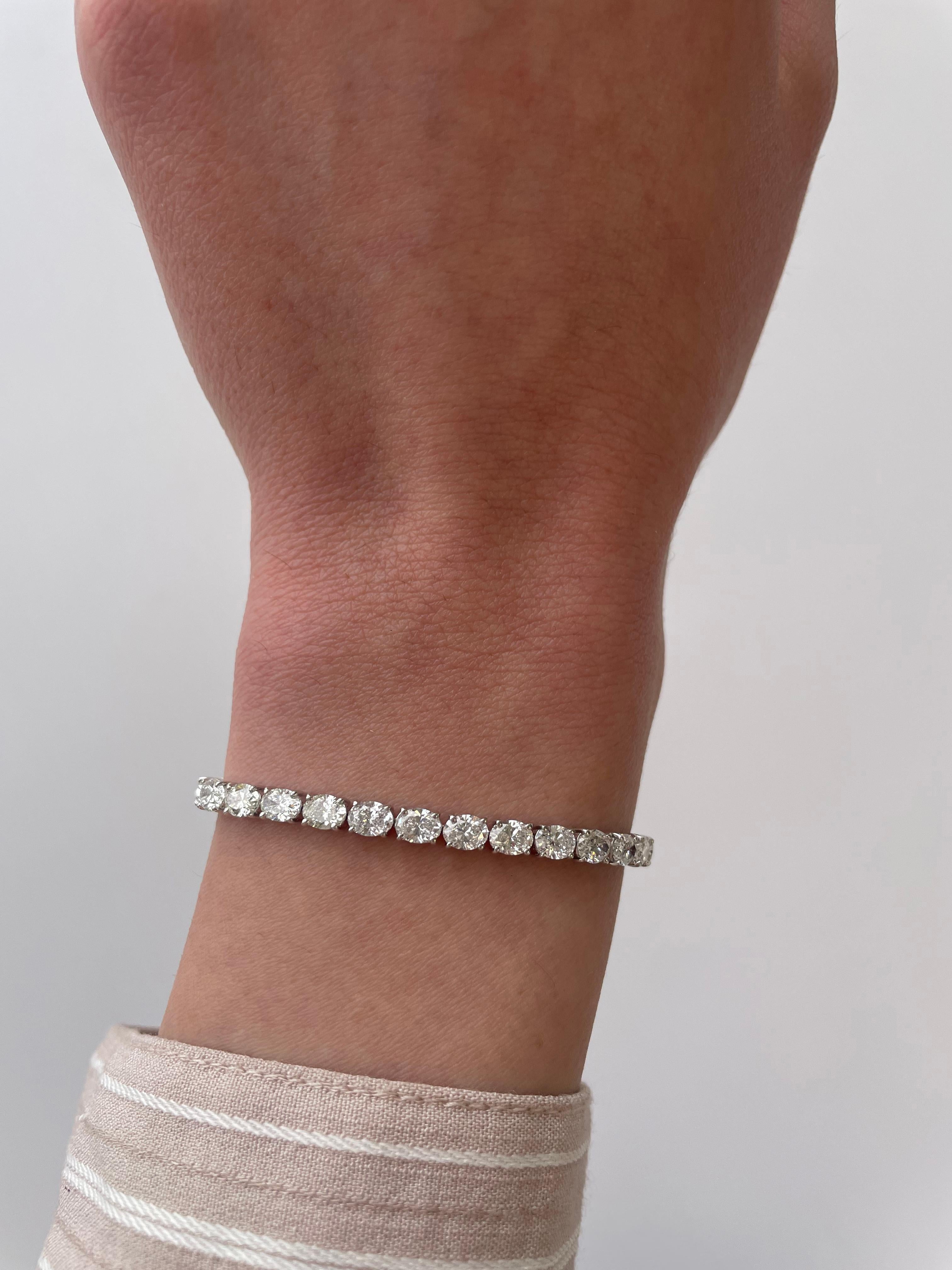 Stunning modern east-west cut diamond tennis bracelet. High jewelry by Alexander Beverly Hills.
36 oval cut diamonds, 8.82 carats. Approximately F/G color and VS2/SI1 clarity. 18k white gold, 8.32 grams, 7 inches.
Accommodated with an up to date