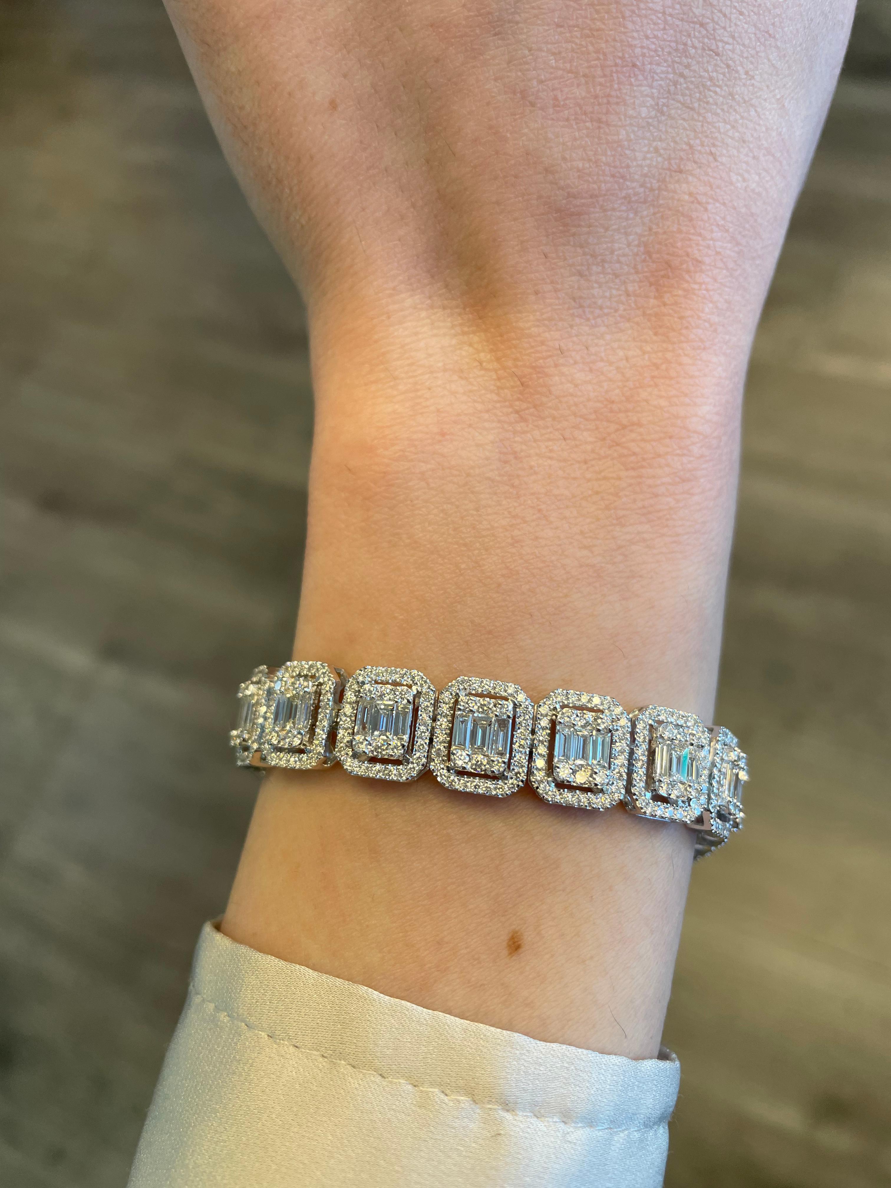 Sensational illusion set diamond bracelet with the look of emerald cut diamonds. High jewelry by Alexander Beverly Hills.
700 round and baguette cut diamonds, 9.06 carats. Approximately G/H color and VS clarity. 18k white gold, 24.97.
Accommodated
