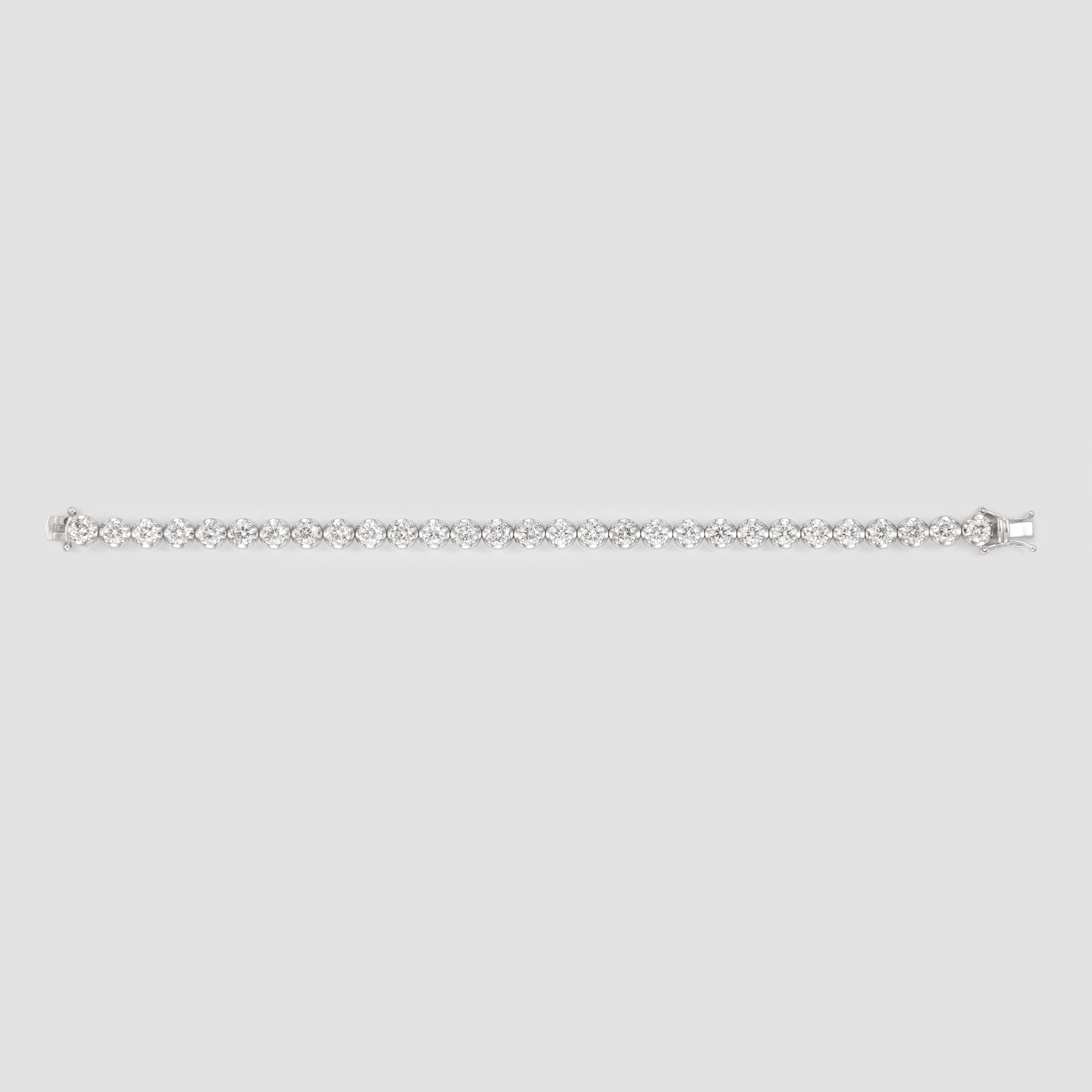 Exquisite and timeless diamonds tennis bracelet. By Alexander of Beverly Hills.
29 round brilliant diamonds, 9.56 carats total. Approximately GH color and SI clarity. Four prong set in 18k white gold.
Accommodated with an up to date appraisal by a