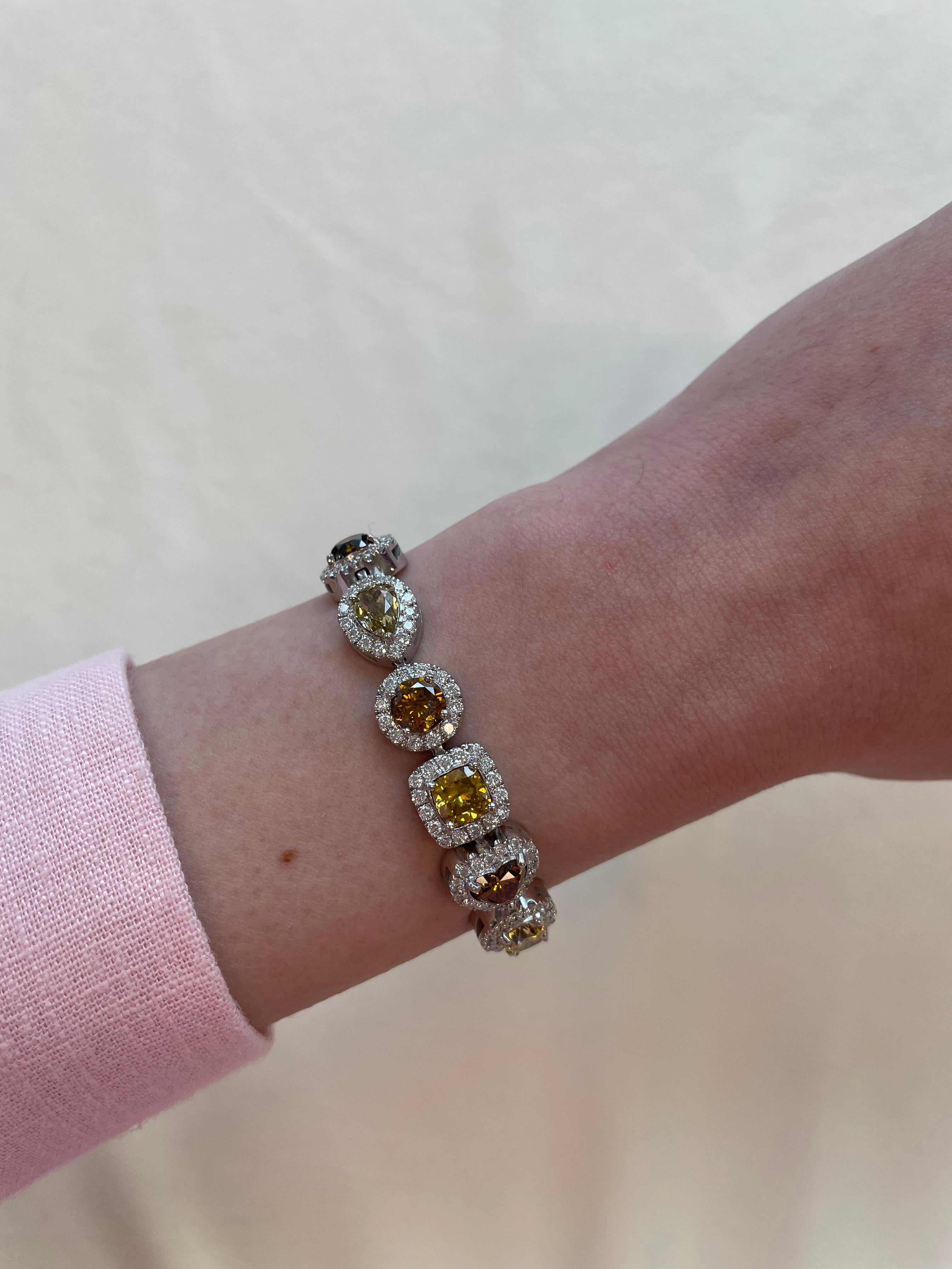 Stunning multi shape and color diamond bracelet with halo. All center stones GIA certified. High jewelry by Alexander Beverly Hills.
18.99 carats total diamond weight. 
16 center stone diamond, 16.11 carats. 4 heart, 3 cushion, 3 round brilliants, 3