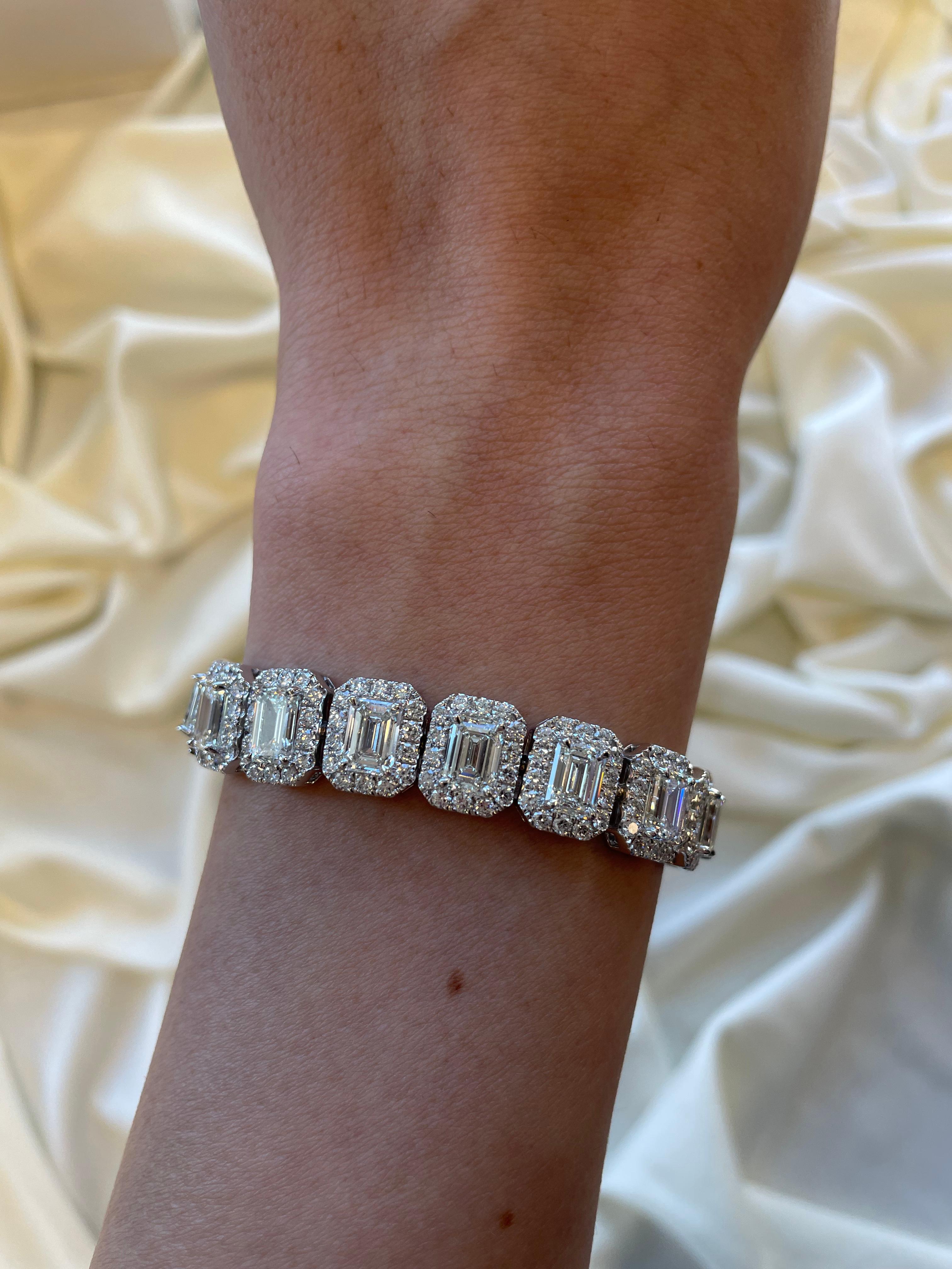 Exceptional modern emerald cut diamond tennis bracelet with halo, all center stones GIA certified. High jewelry by Alexander Beverly Hills.
26.55 carat total diamond weight. 
20 GIA certified emerald cut diamonds, 20.18 carats (each stone 1ct or
