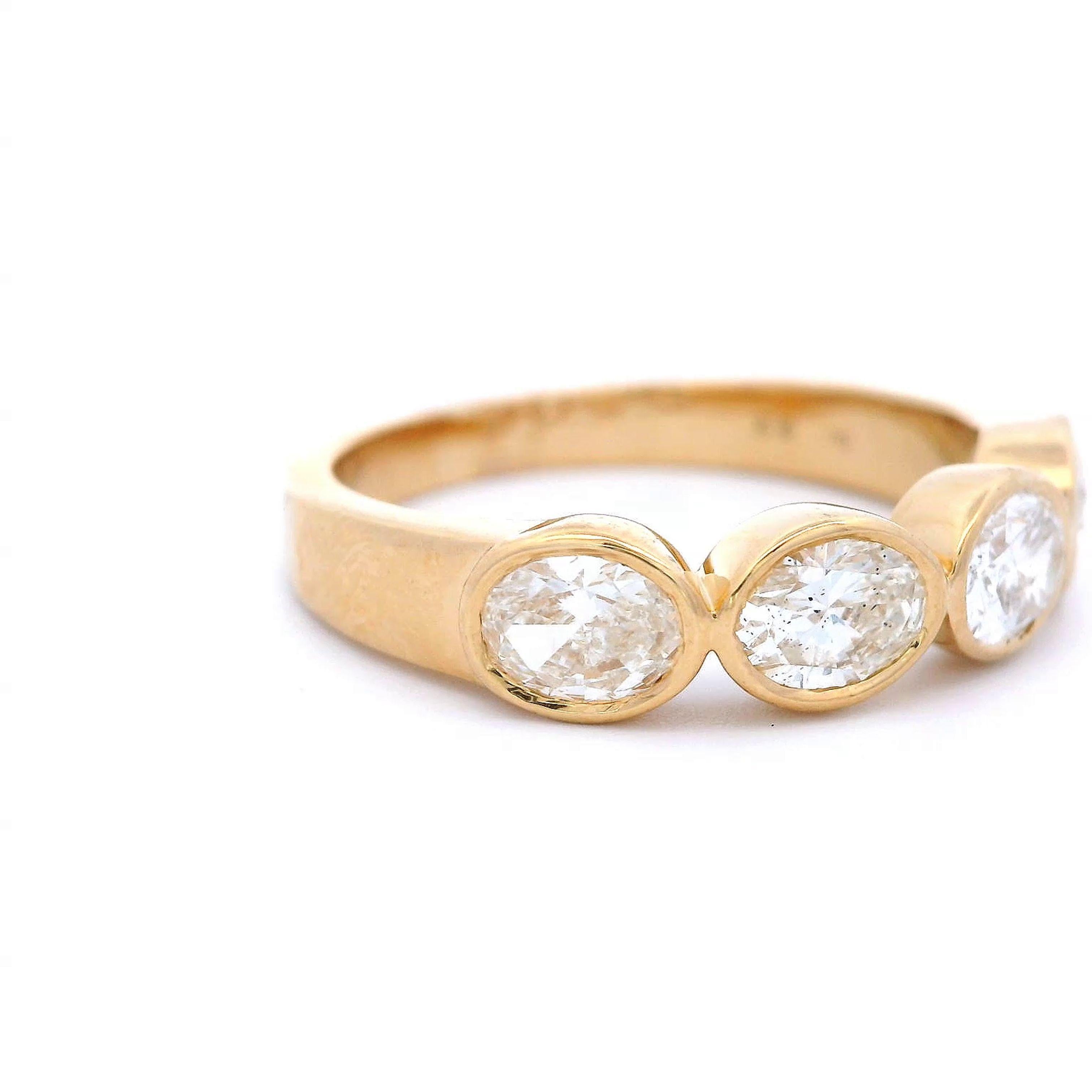 Stunning modern oval cut diamond east-west eternity band bezel set, by Alexander Beverly Hills.
4 oval diamonds, 1.01 carats total. F/G color and SI clarity. Bezel set in 18k yellow gold, 4.50 grams, size 6.5.
Accommodated with an up to date digital