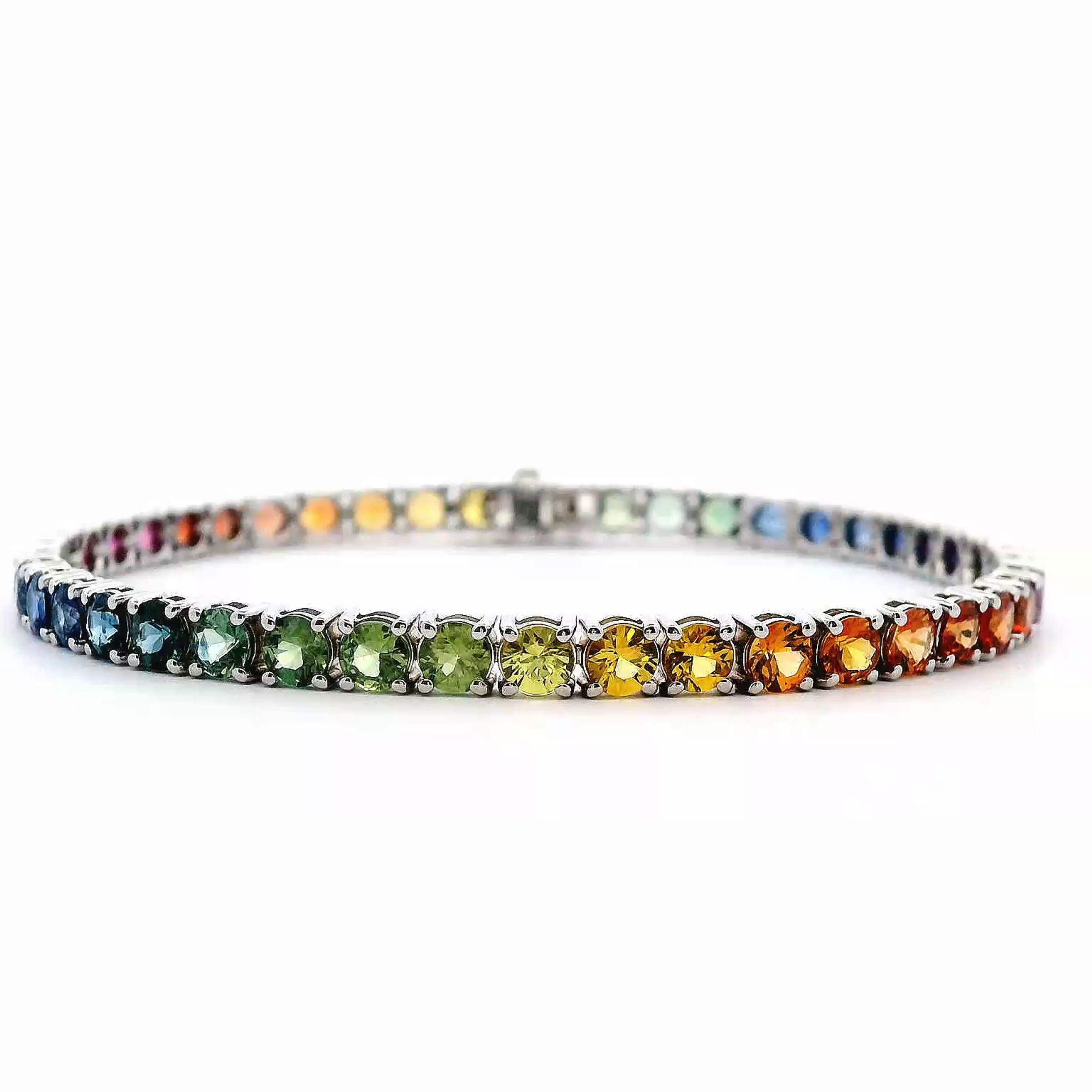 Exquisite and perfectly graduated rainbow multi color sapphire tennis bracelet, by Alexander Beverly Hills.
45 round sapphires, 10.23 carats total. Four prong set in 18k white gold, 11.12 grams, 7 inches.
Accommodated with an up-to-date digital