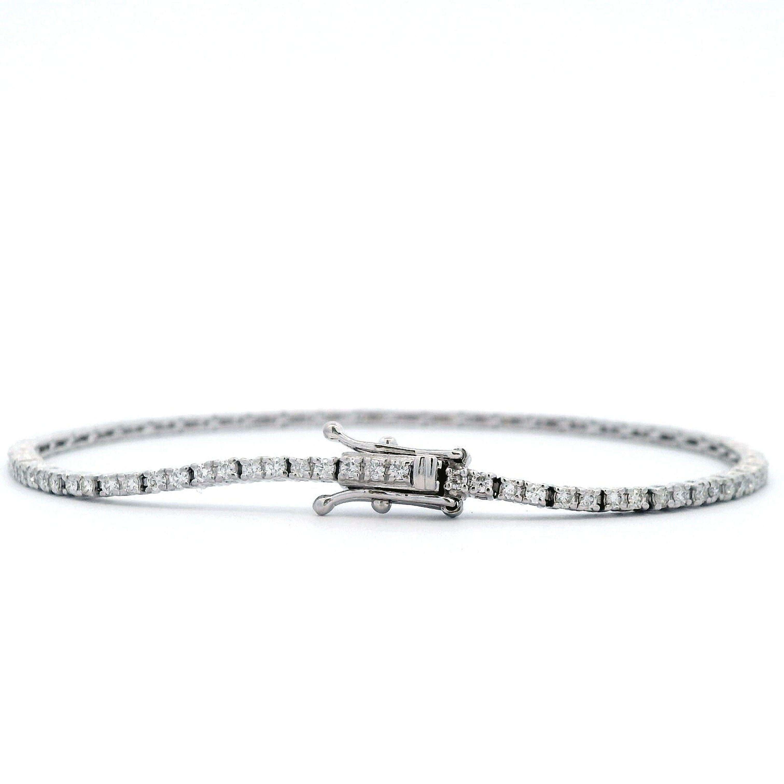 Exquisite and timeless diamonds tennis bracelet, by Alexander Beverly Hills.
95 round brilliant diamonds, 1.03 carats total. Approximately F/G color and VS1 clarity. Four prong set in 18k white gold, 6.60 grams, 7.25 inches.
Accommodated with an