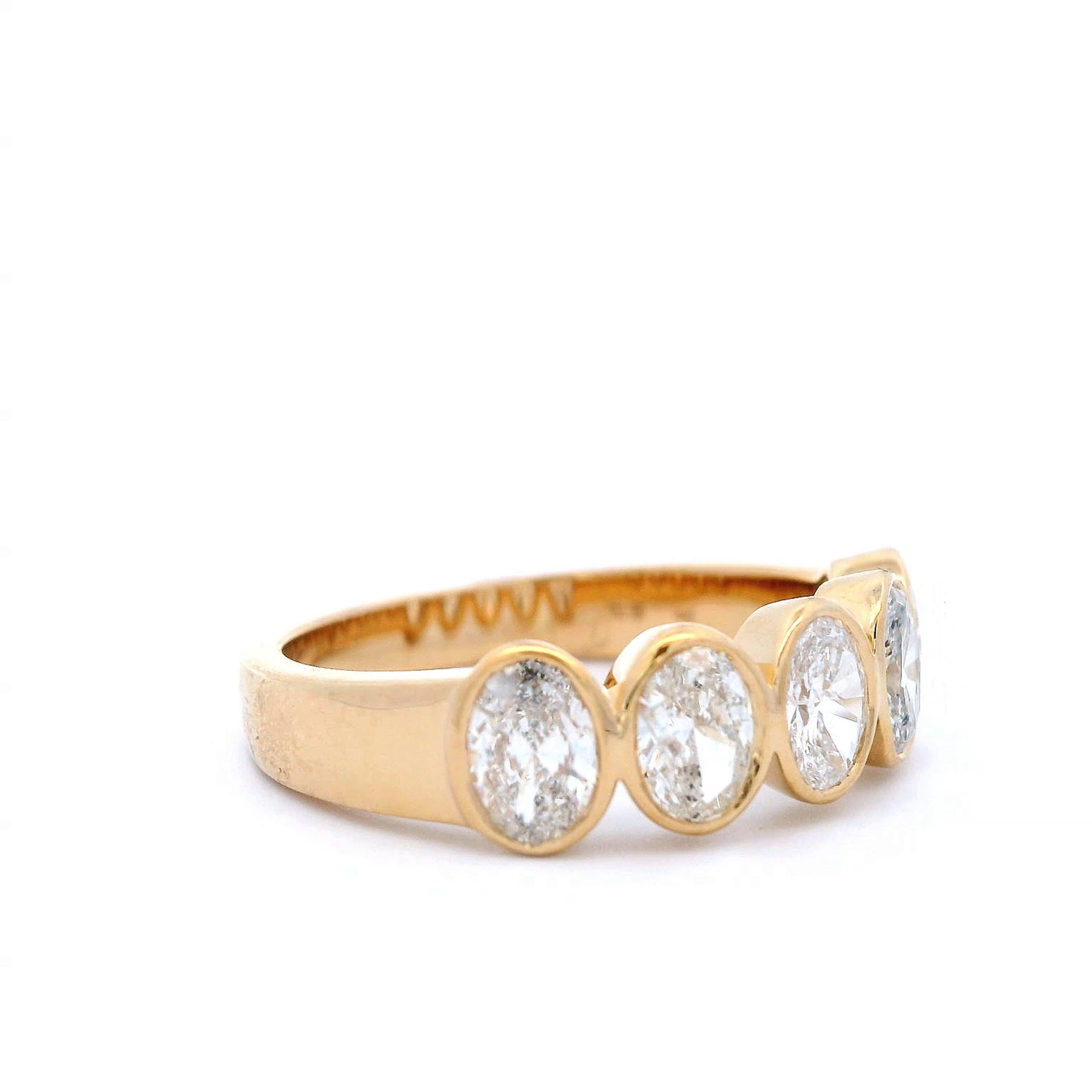 Stunning modern oval cut diamond eternity band bezel set, by Alexander Beverly Hills.
5 oval diamonds, 1.25 carats total. G/H color and SI2 clarity. Bezel set in 18k yellow gold, 5.15 grams, size 6.5.
Accommodated with an up to date digital