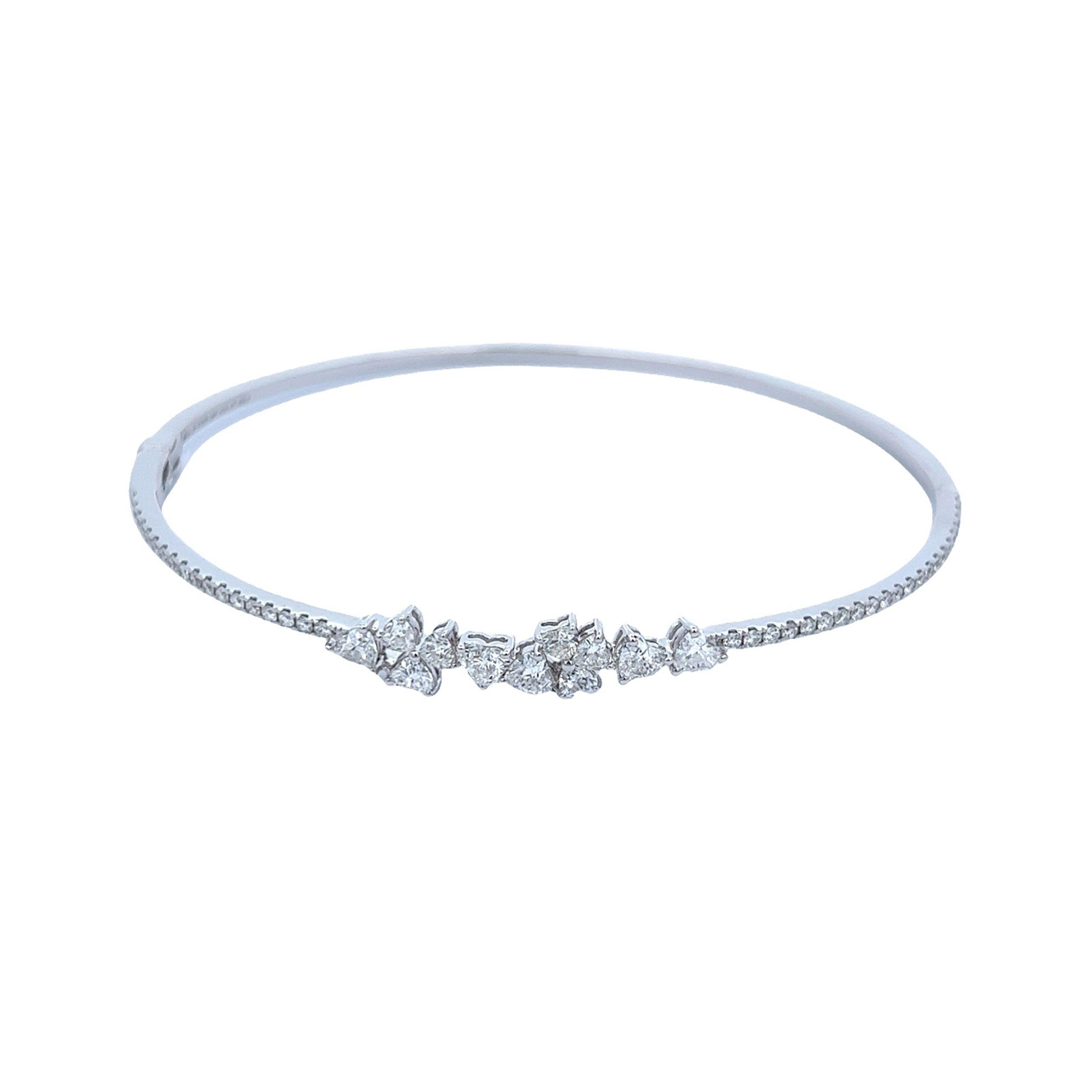 Exquisite modern diamond cluster bangle, by Alexander Beverly Hills.
1.27 carats total diamond weight. 
11 heart diamonds, 0.91 carats. Approximately D/F color VVS2-VS1 clarity. 40 round diamonds, 0.36 carats. Approximately E/F color and VS clarity.