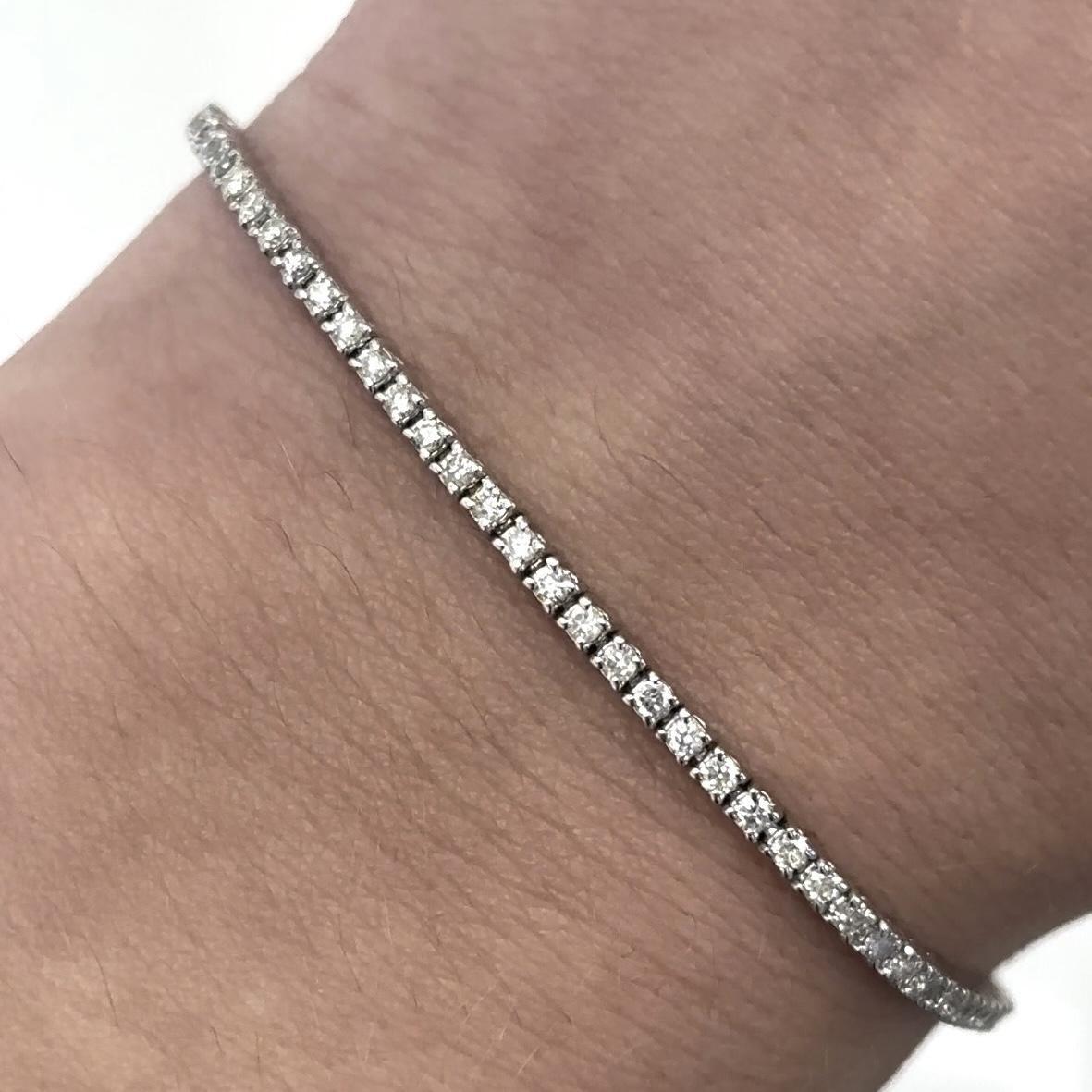 Exquisite and timeless diamonds tennis bracelet, by Alexander Beverly Hills.
80 round brilliant diamonds, 1.28 carats total. Approximately F/G color and VS2 clarity. Four prong set in 18k white gold, 7.24 grams, 7.25 inches.
Accommodated with an