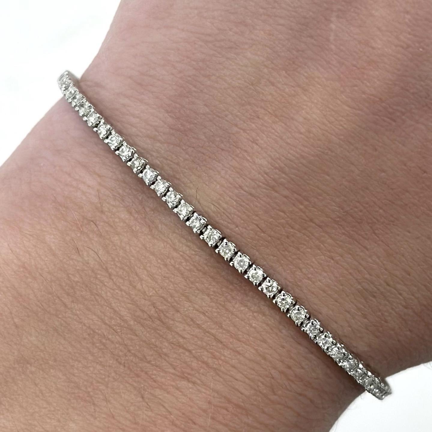 Exquisite and timeless diamonds tennis bracelet, by Alexander Beverly Hills.
90 round brilliant diamonds, 1.28 carats total. Approximately J-L color and SI clarity. Four prong set in 18k white gold, 6.12 grams, 7 inches.
Accommodated with an