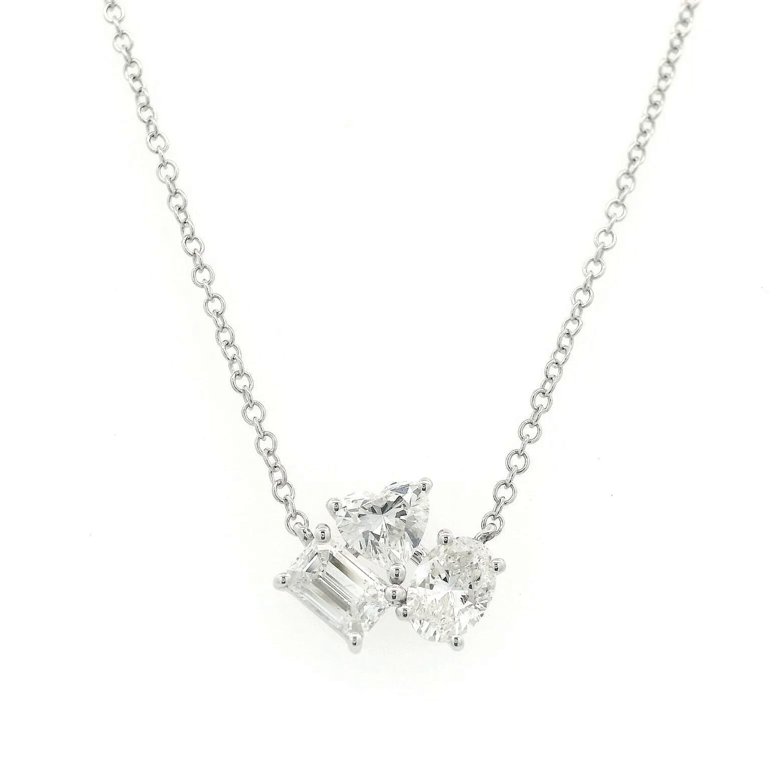 Modern mixed diamond pendant necklace. By Alexander Beverly Hills.
1 oval, 1 heart, and 1 emerald cut diamond, 1.30 carats. Approximately F/G color grade and SI clarity. 18-karat yellow gold, 3.15 grams, 16-18 inches.
Accommodated with an up to date